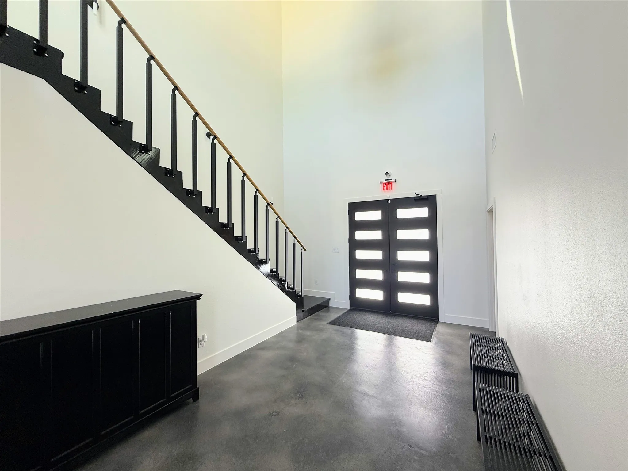 Two-story entryway with high ceilings and polished concrete flooring