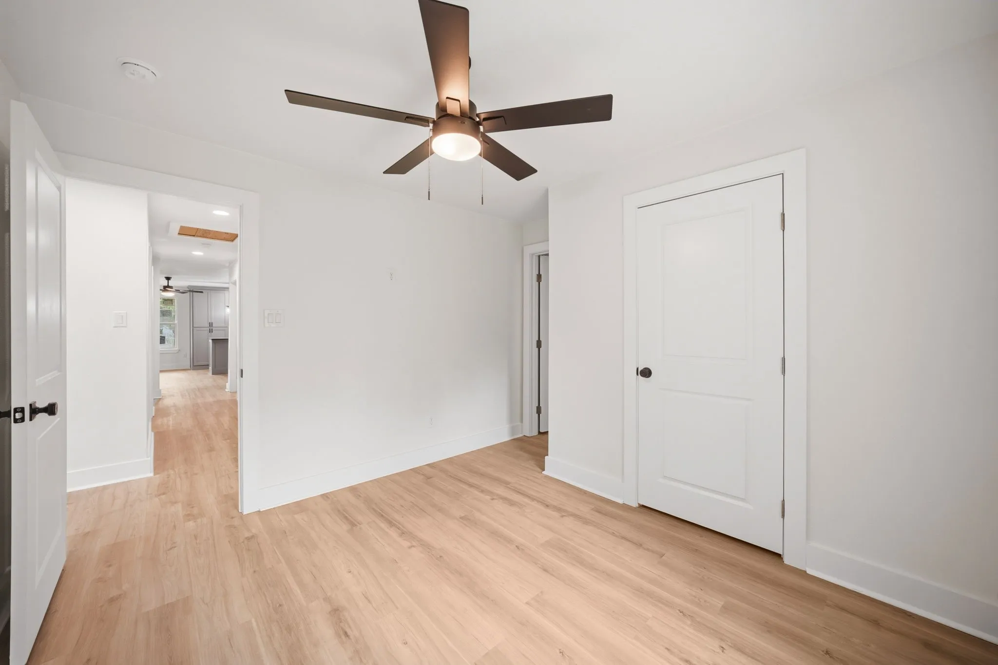 Neutral-toned wood-finish flooring throughout
