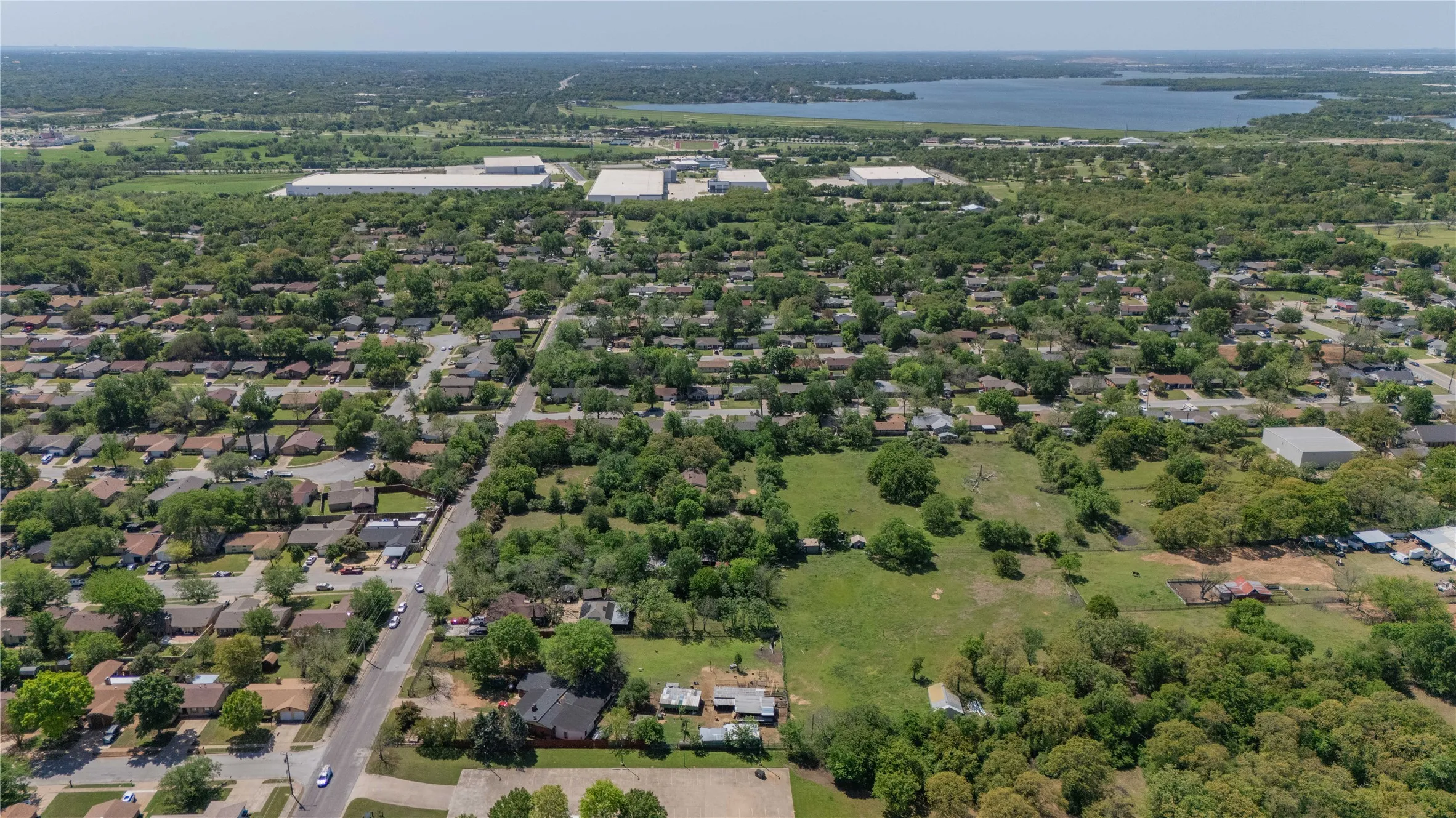 Expansive aerial view showcasing a residential area with dense tree coverage