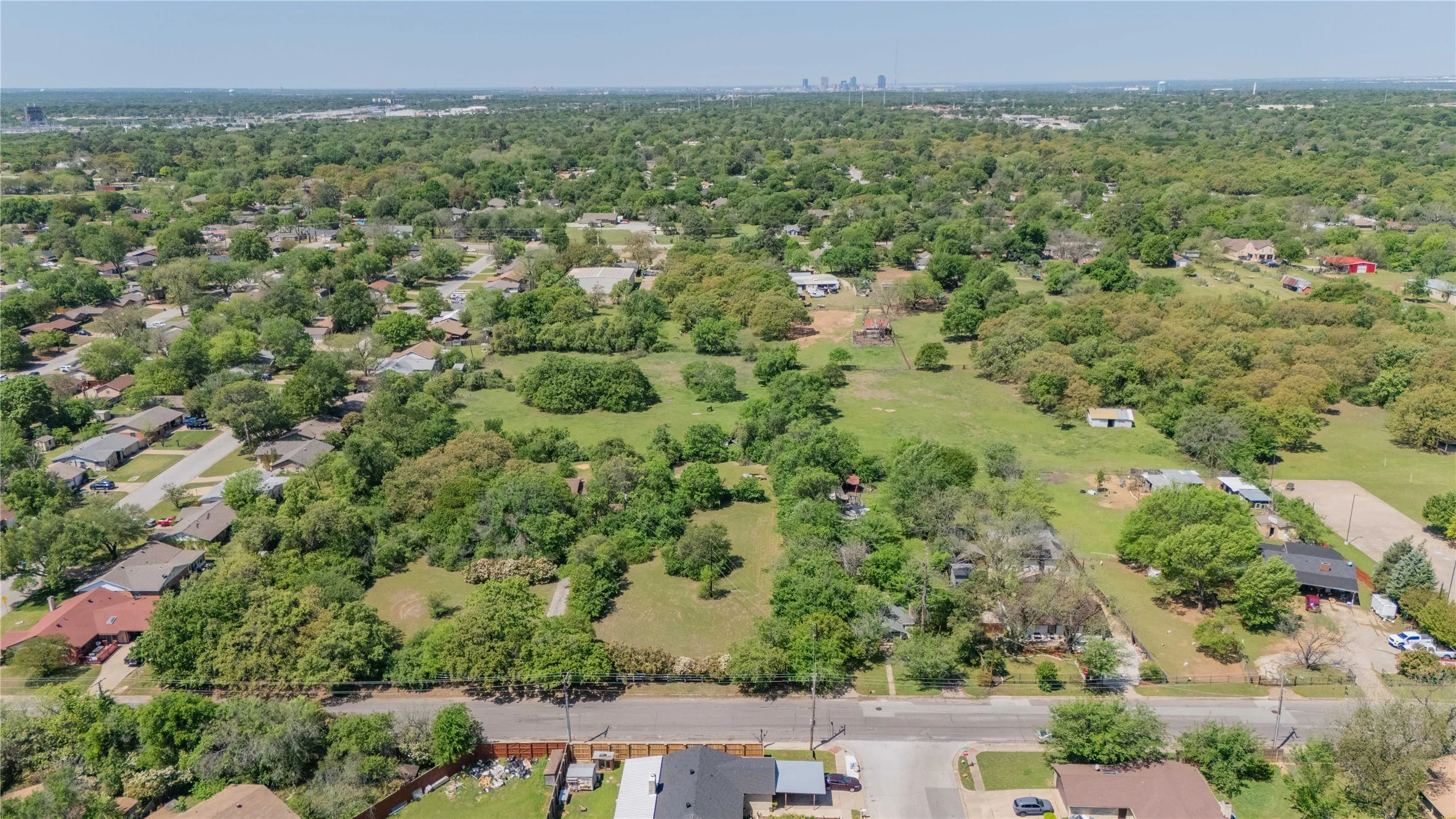Expansive green spaces featuring mature trees and clearings