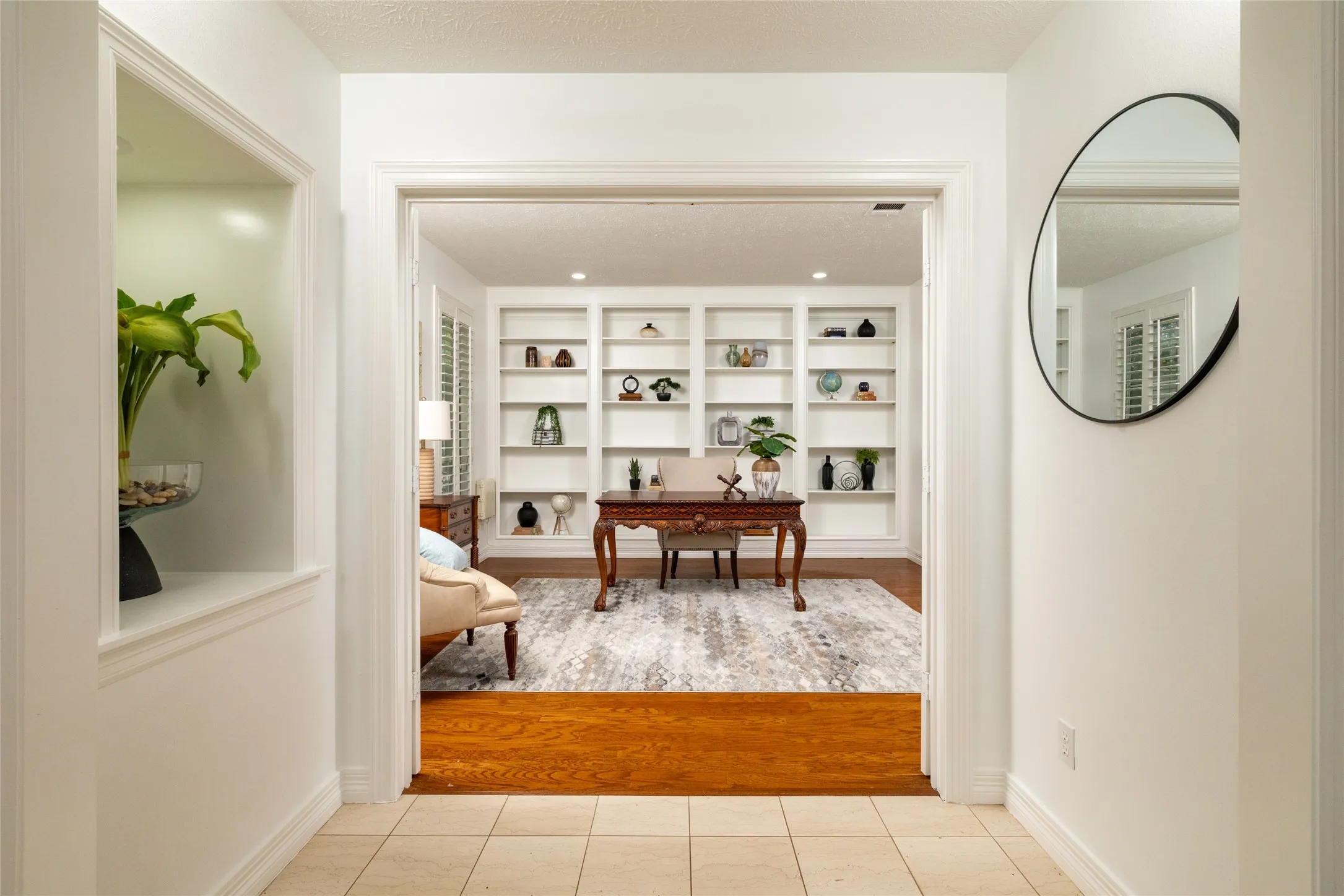Alcove into the executive study with a lighted art niche