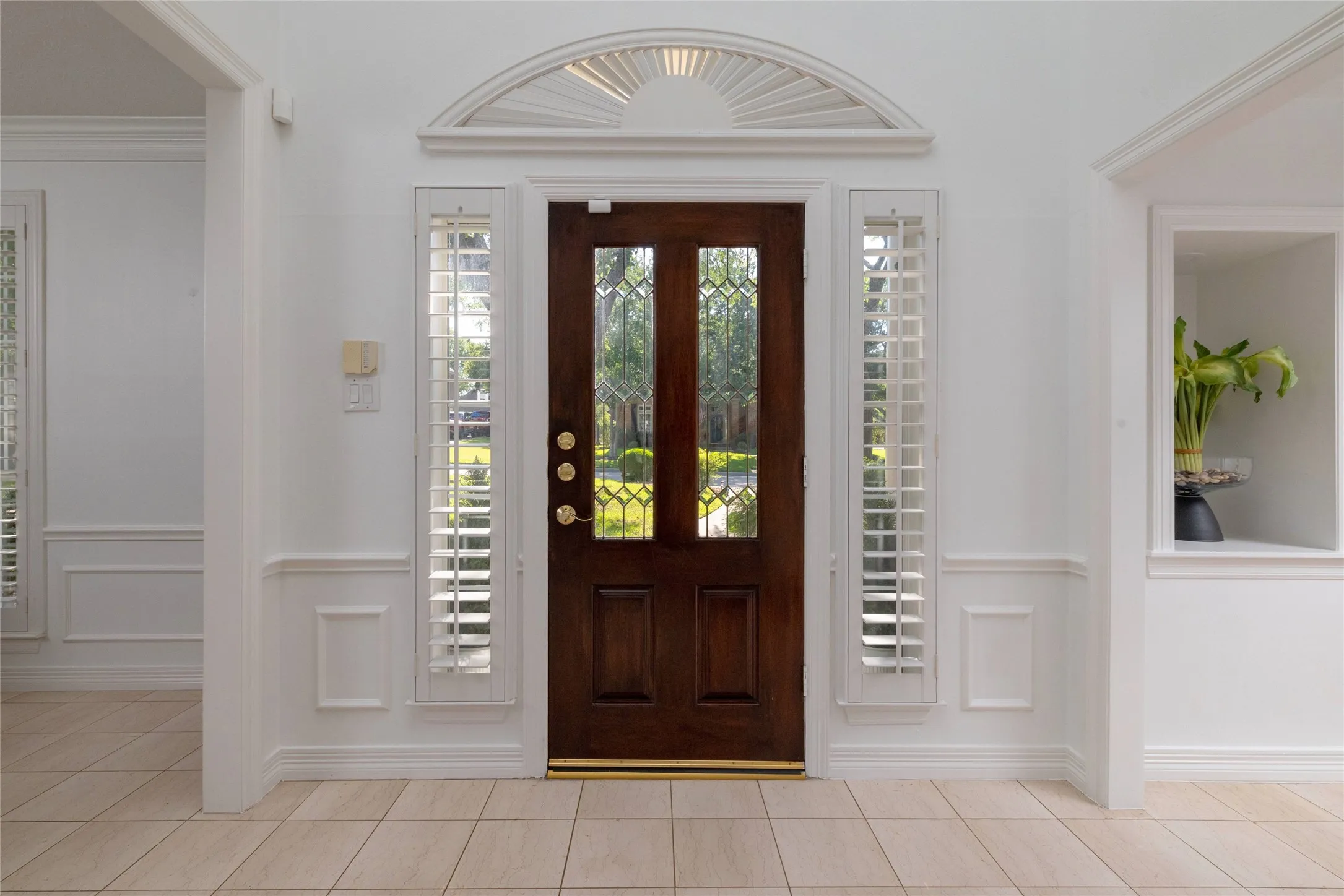 Timeless elegance with polished marble, lead glass, and plantation shutters