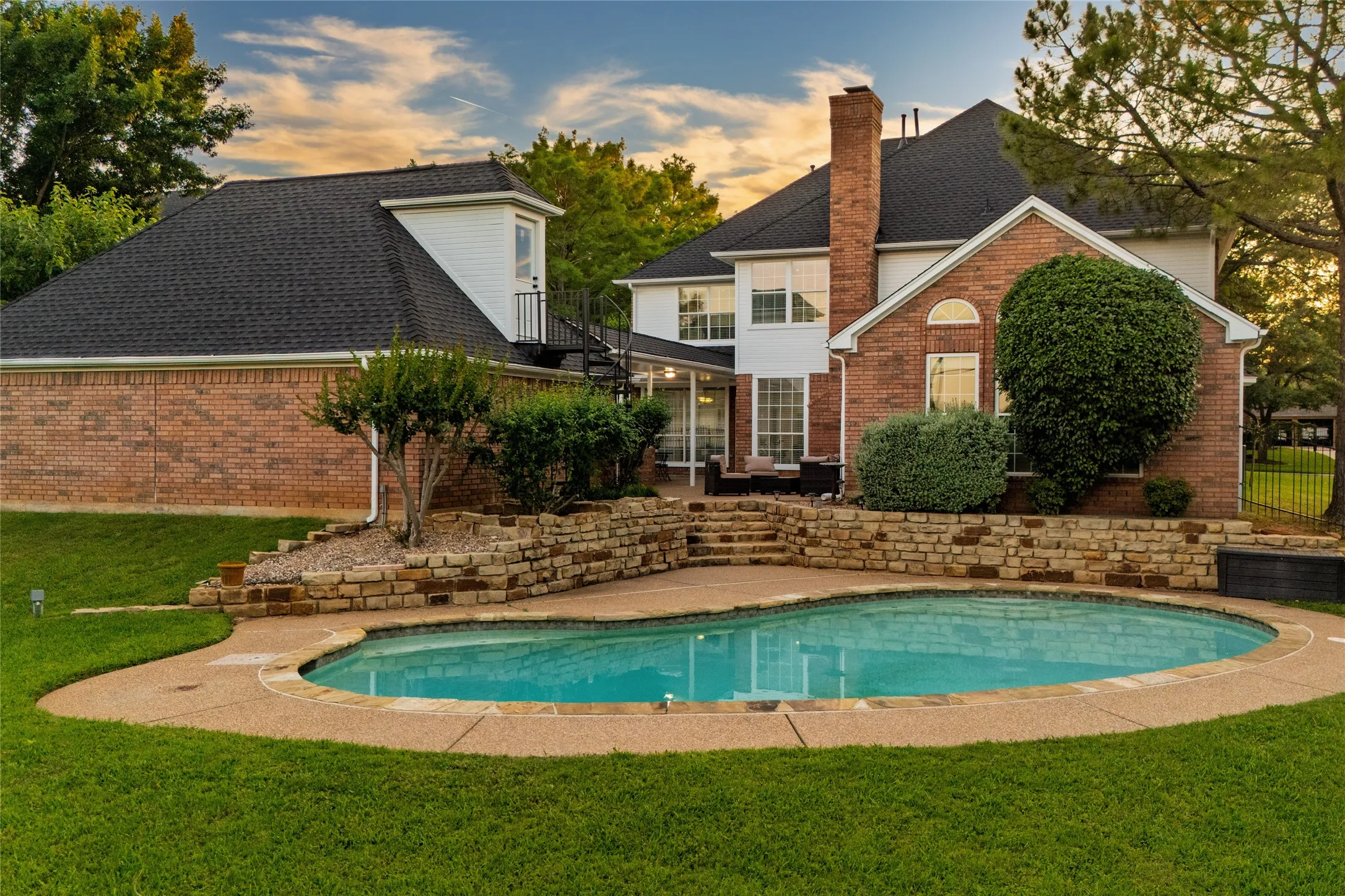 A backyard built for summer parties! The pool is deep, but the diving board was removed.