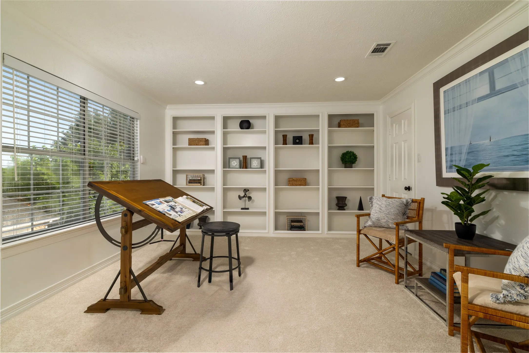 French doors lead into the 5th bedroom with a wall of built-ins.