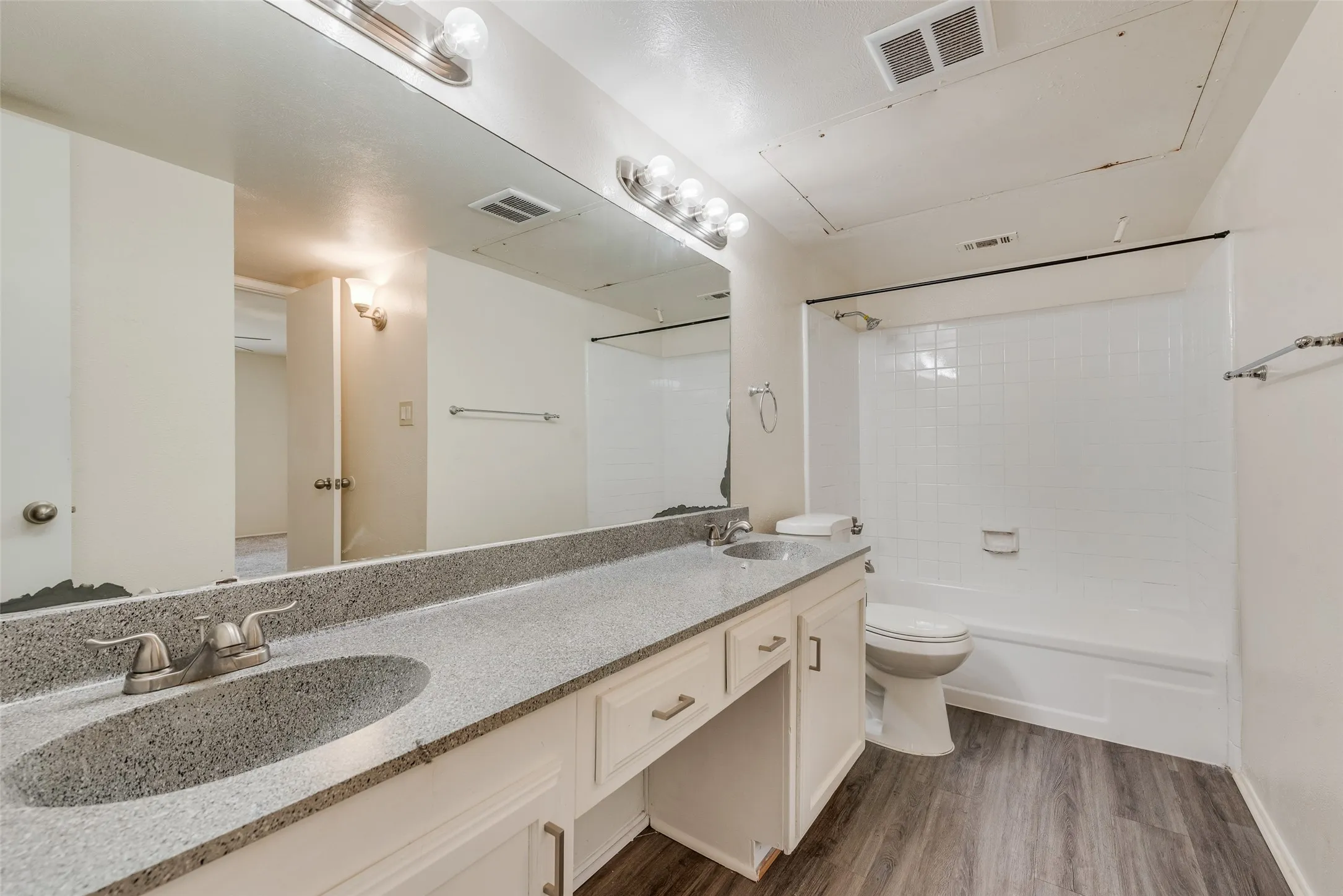 Dual vanity with integrated sinks and a speckled countertop