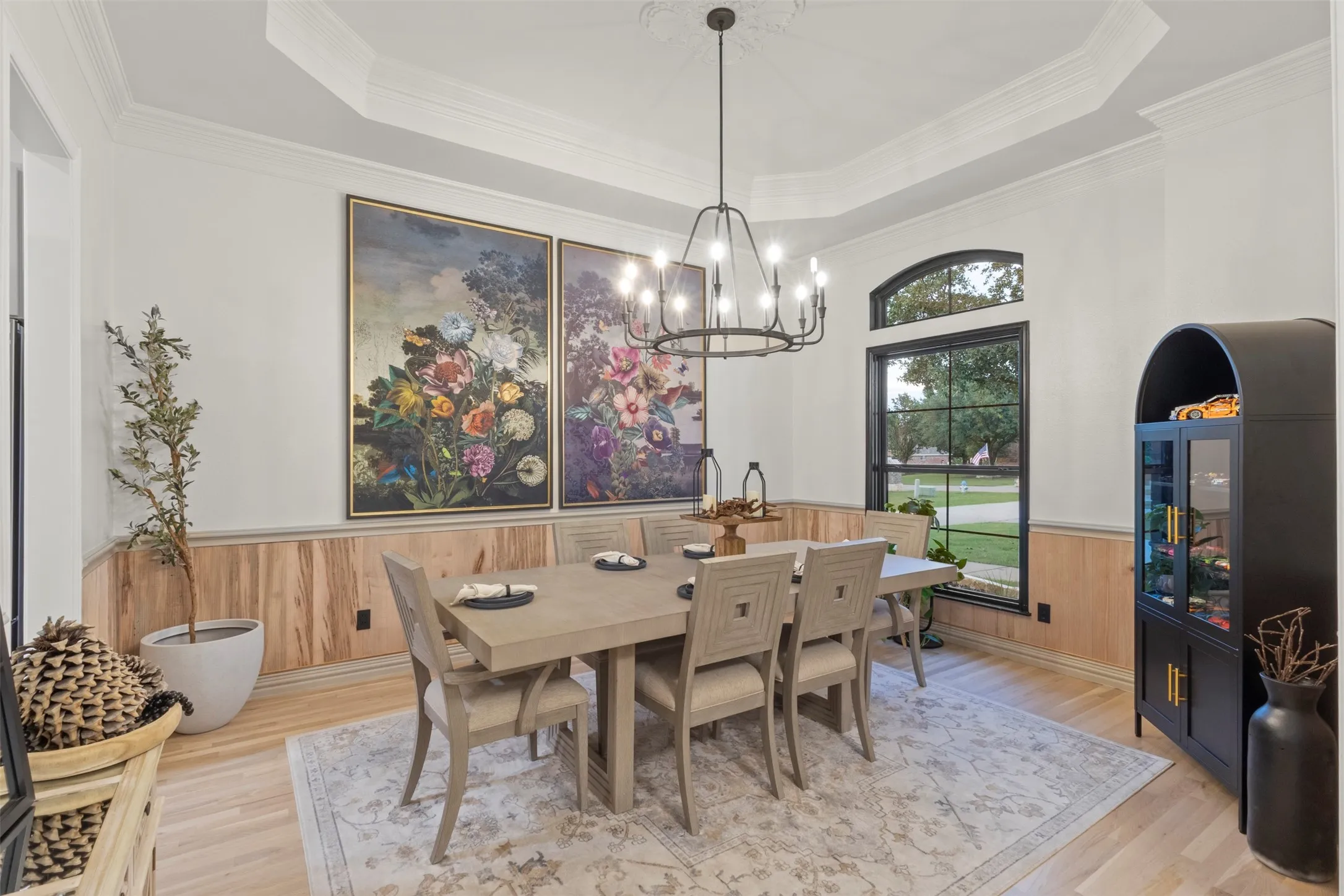 Elegant formal dining room color drenched in Toque White, showcasing a tray ceiling, crown molding, and custom Ambrosia maple wood paneling with sand-tone trim—creating a refined, designer-finished space for elevated dining and entertaining.
