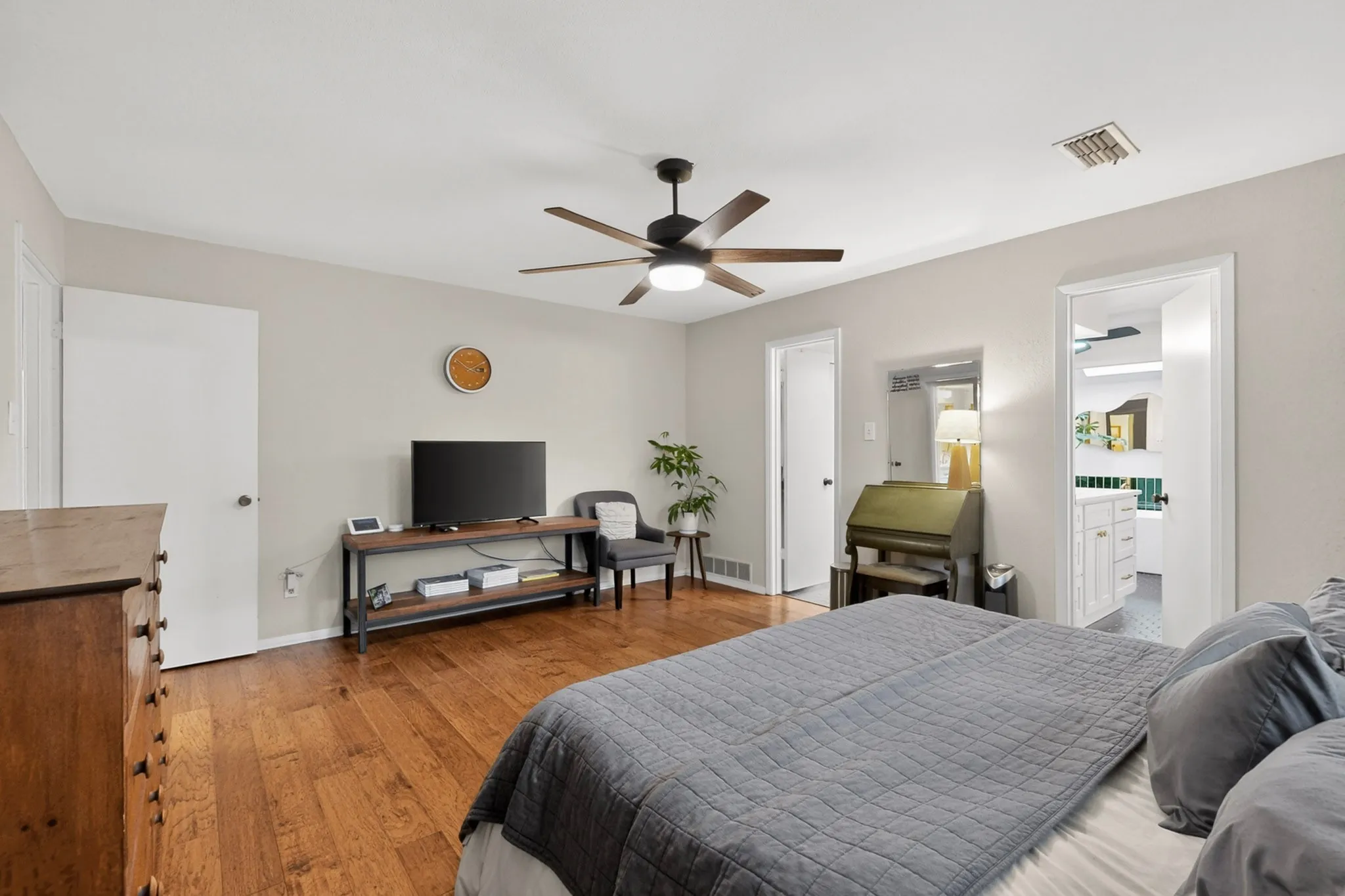 Bedroom featuring hardwood flooring and light gray wall paint
