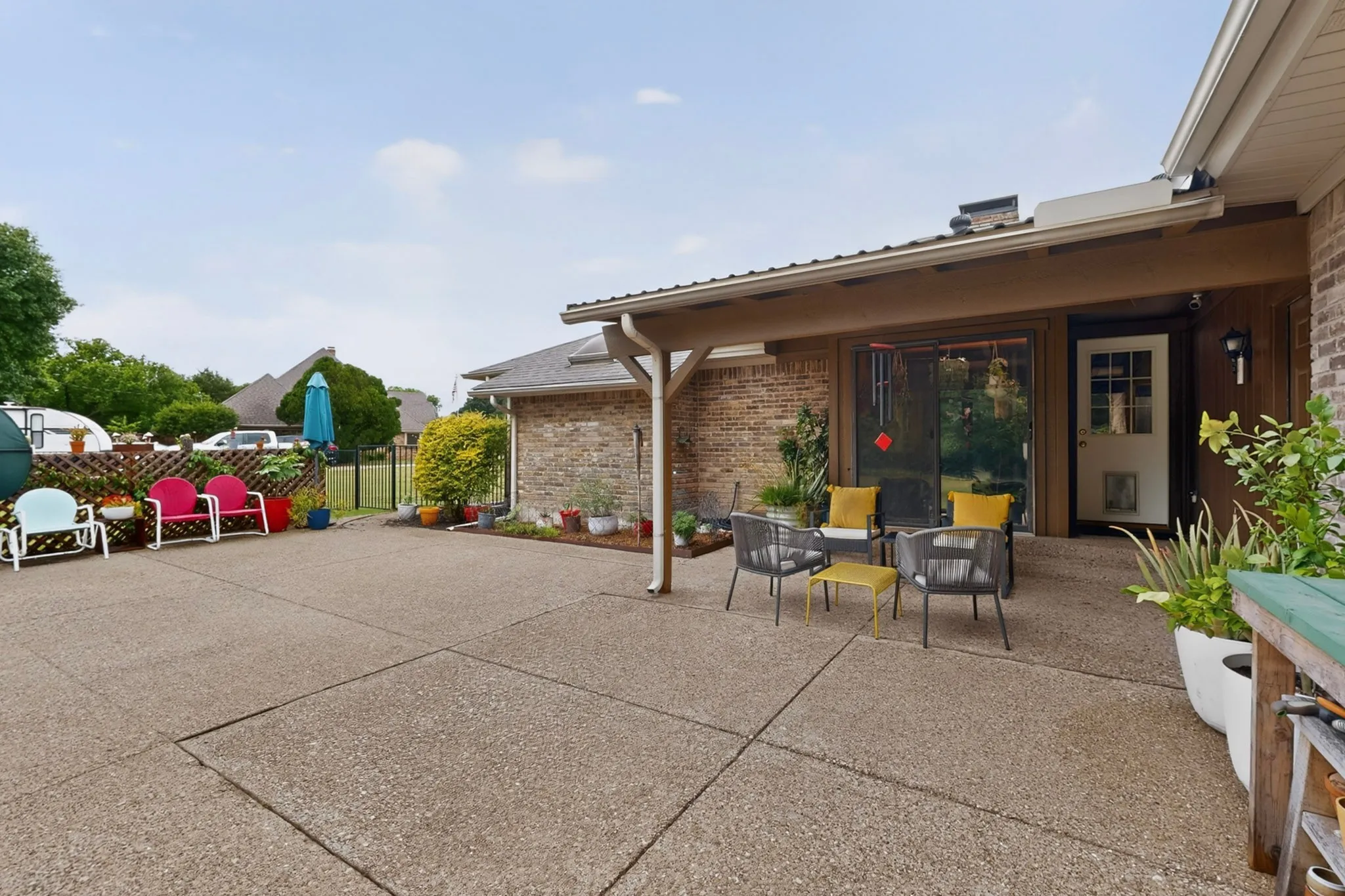 Expansive concrete patio area with a covered porch