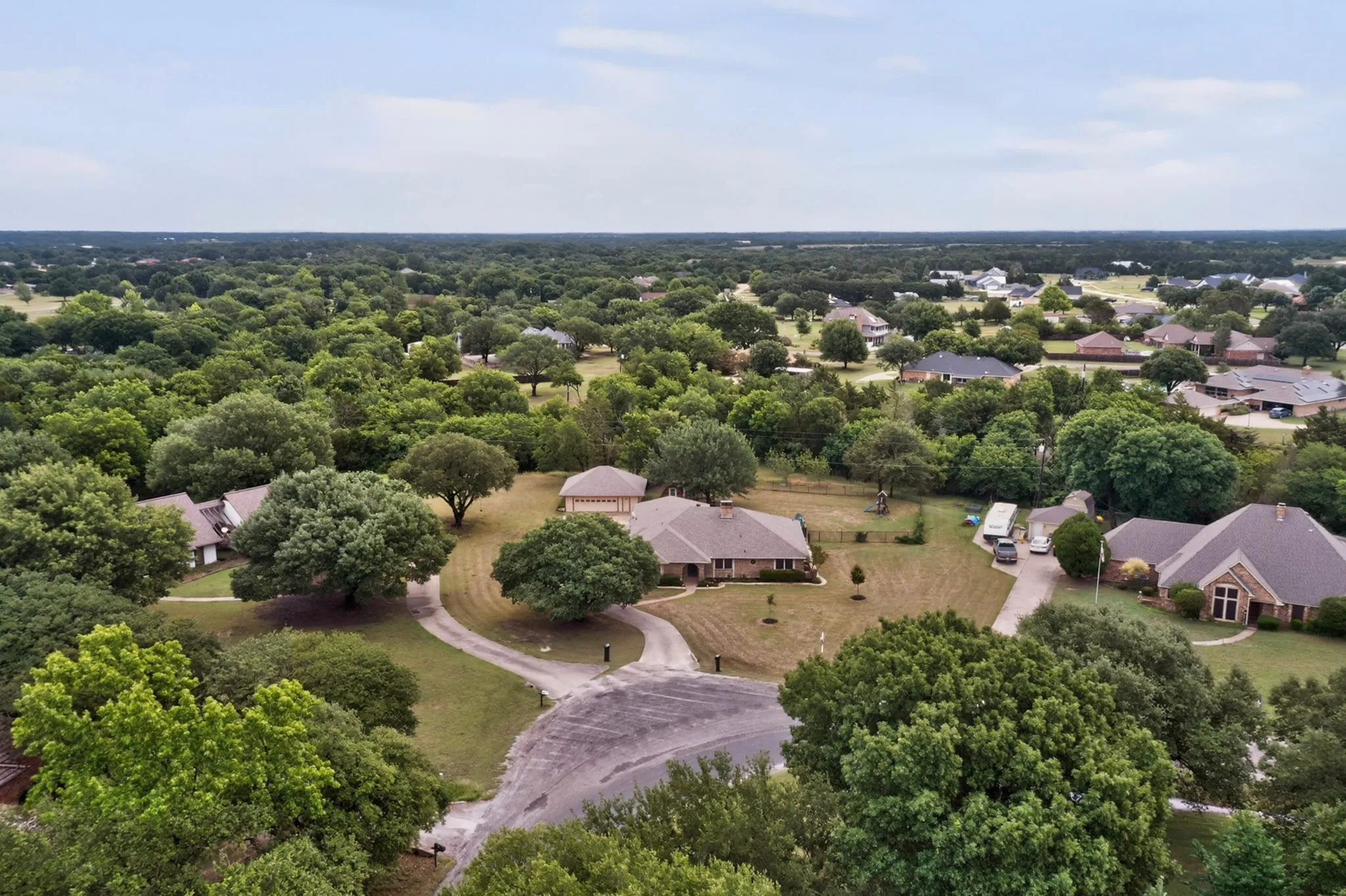 Expansive residential area featuring numerous mature trees and substantial green spaces