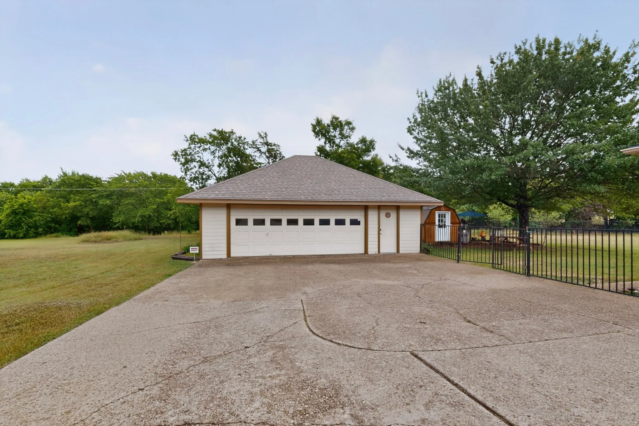 Detached two-car garage with a pitched roof and a concrete driveway