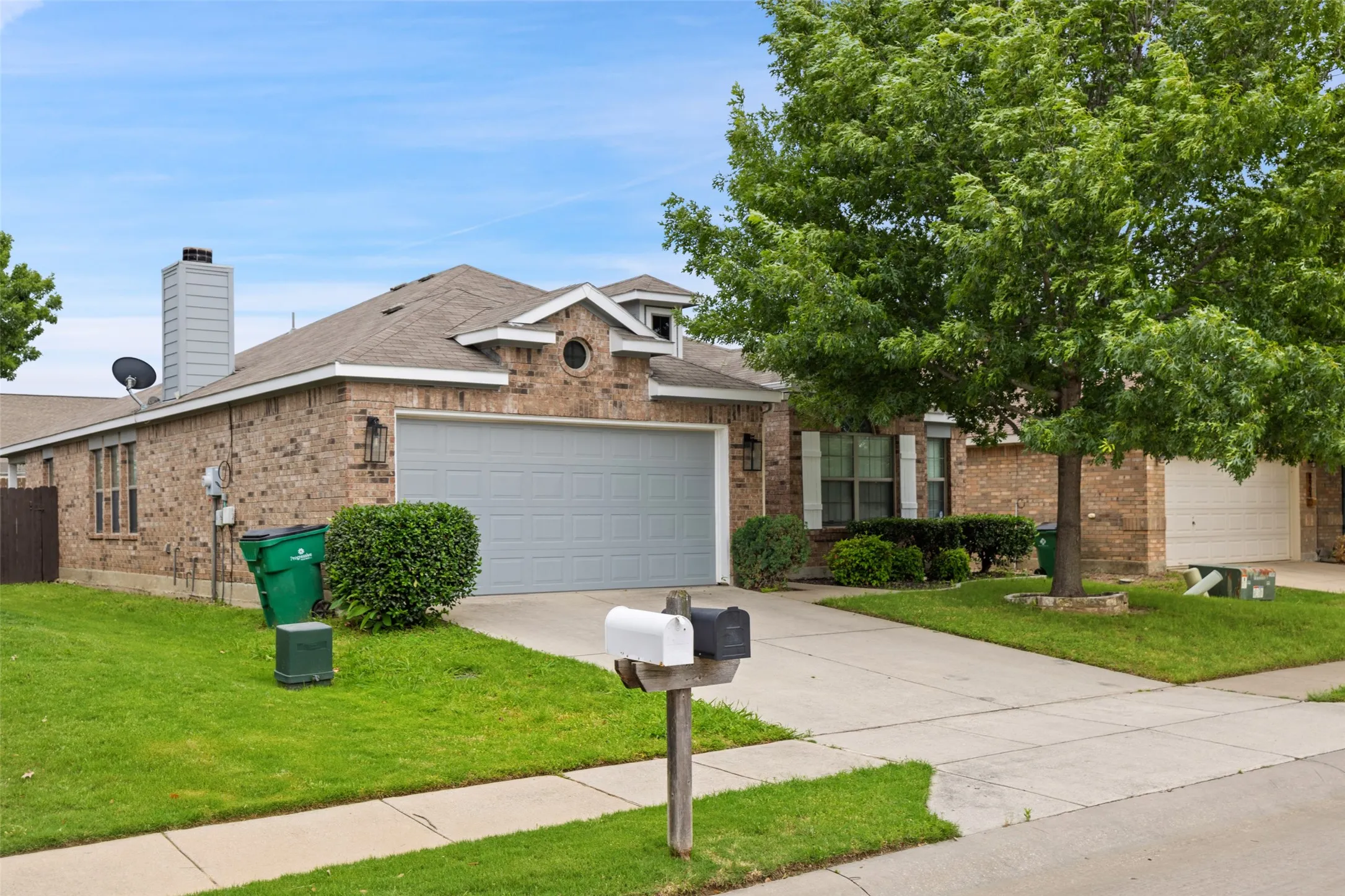 View of front of home with a front yard and a garage