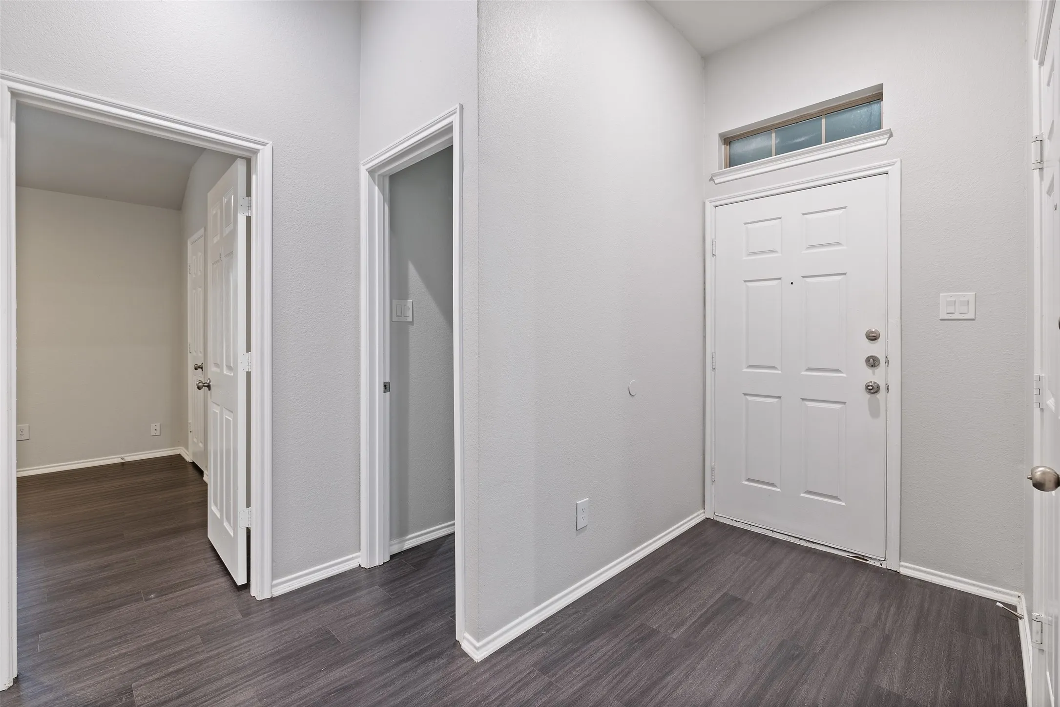 Foyer entrance featuring dark hardwood / wood-style flooring