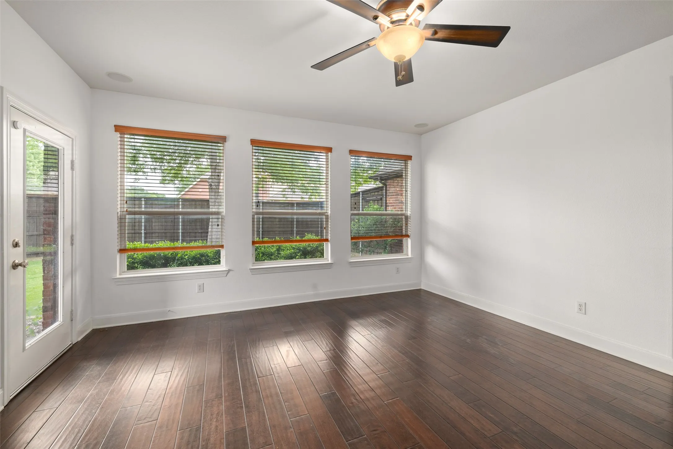 Featuring ceiling fan and dark wood-type flooring