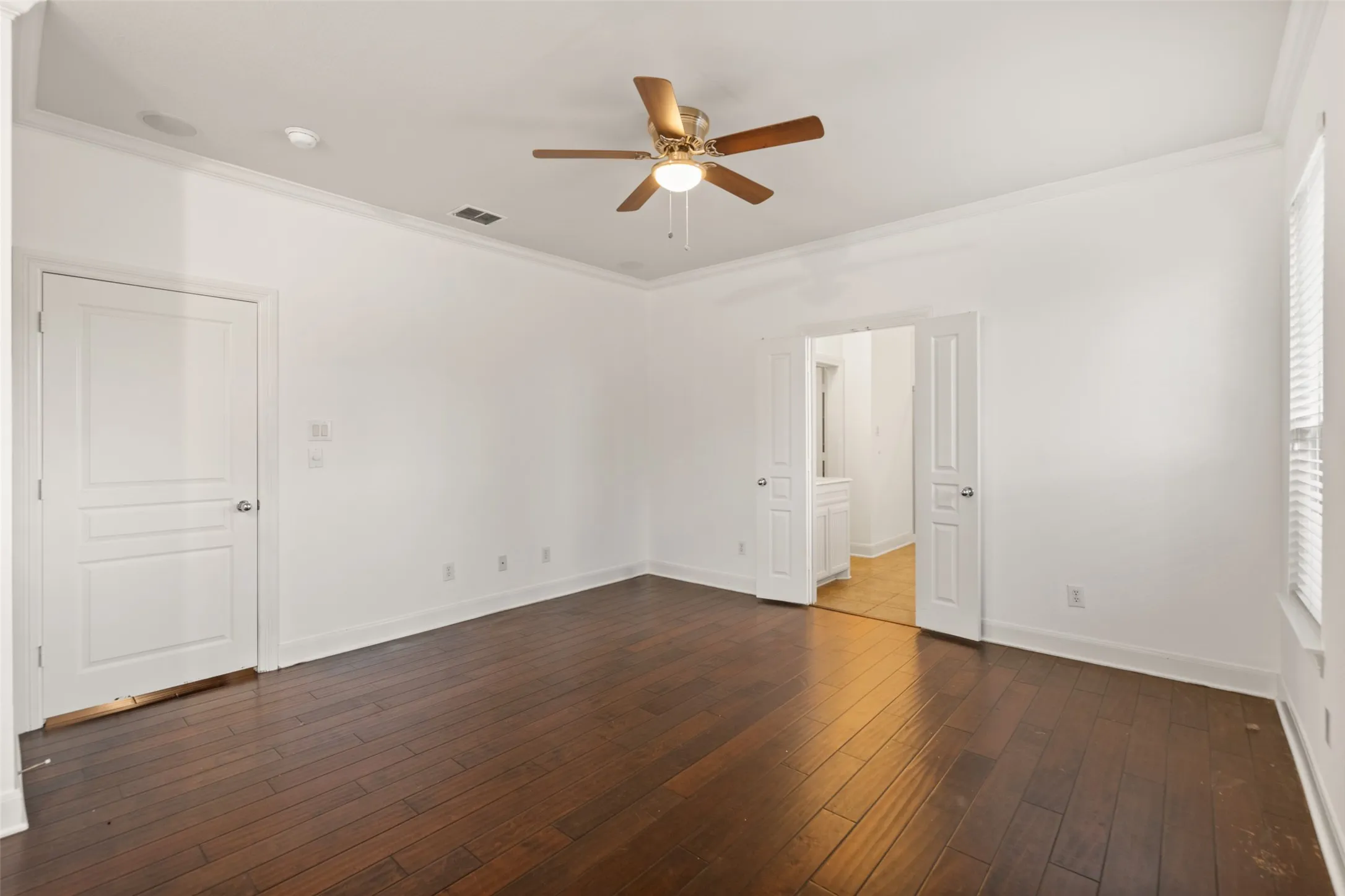 Featuring ceiling fan, dark hardwood / wood-style flooring, and ornamental molding