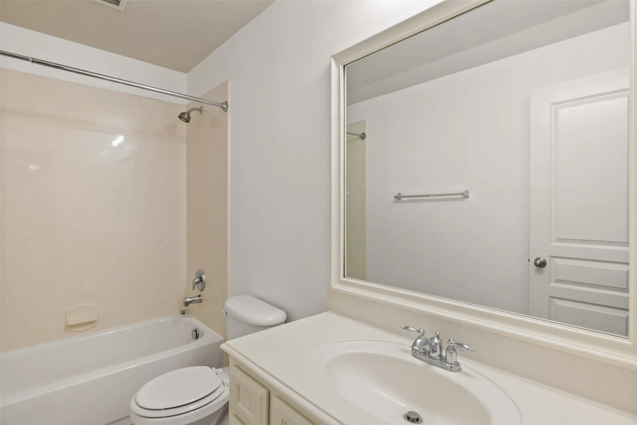 Full bathroom with vanity with extensive cabinet space, toilet, and bathtub / shower combination