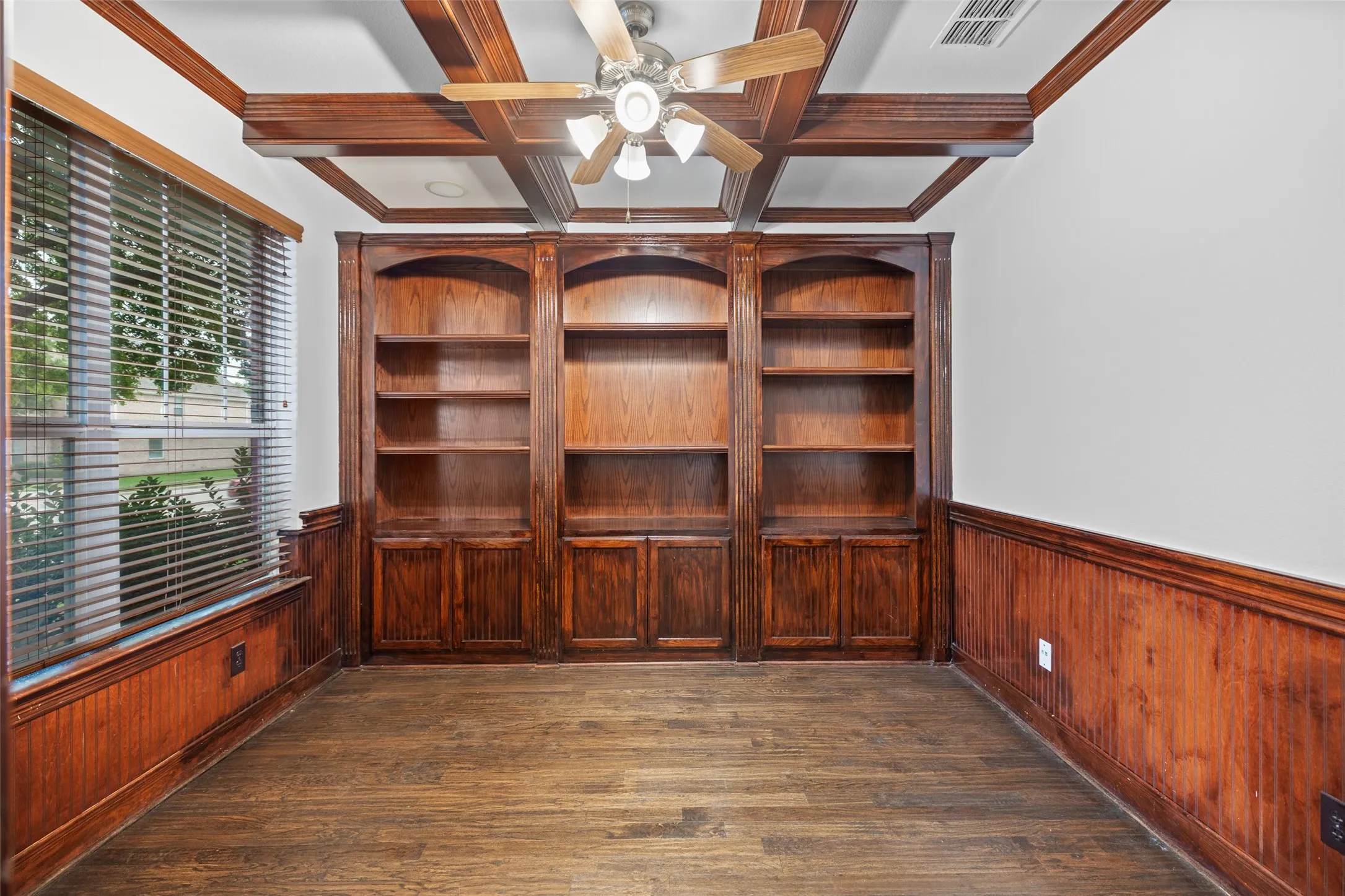 Office room featuring ceiling fan, dark hardwood / wood-style flooring, crown molding, and coffered ceiling