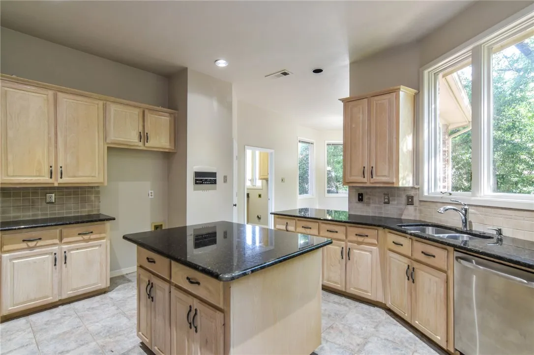 Another view of the kitchen with granite counters