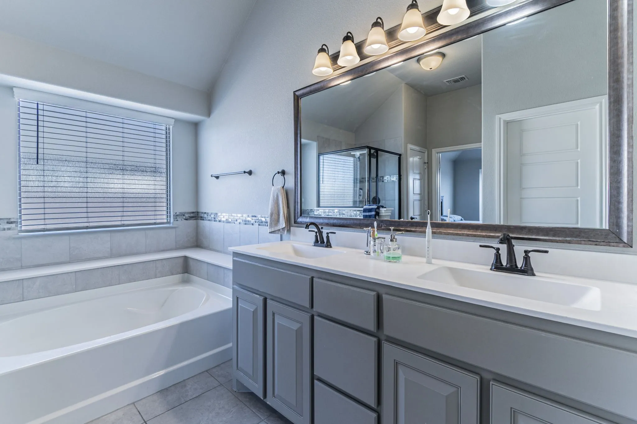 Double vanity with integrated sinks and black-finish fixtures