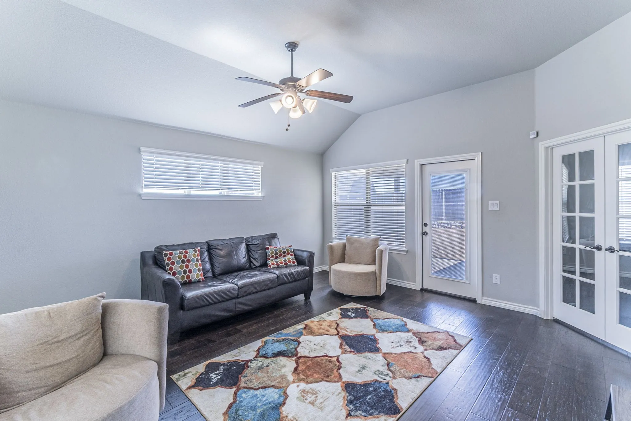 Vaulted ceiling with a ceiling fan featuring integrated lighting