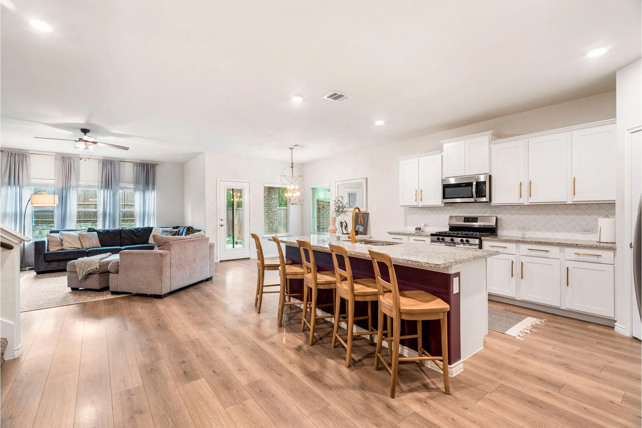 Open-concept kitchen and living area featuring wood-finish flooring
