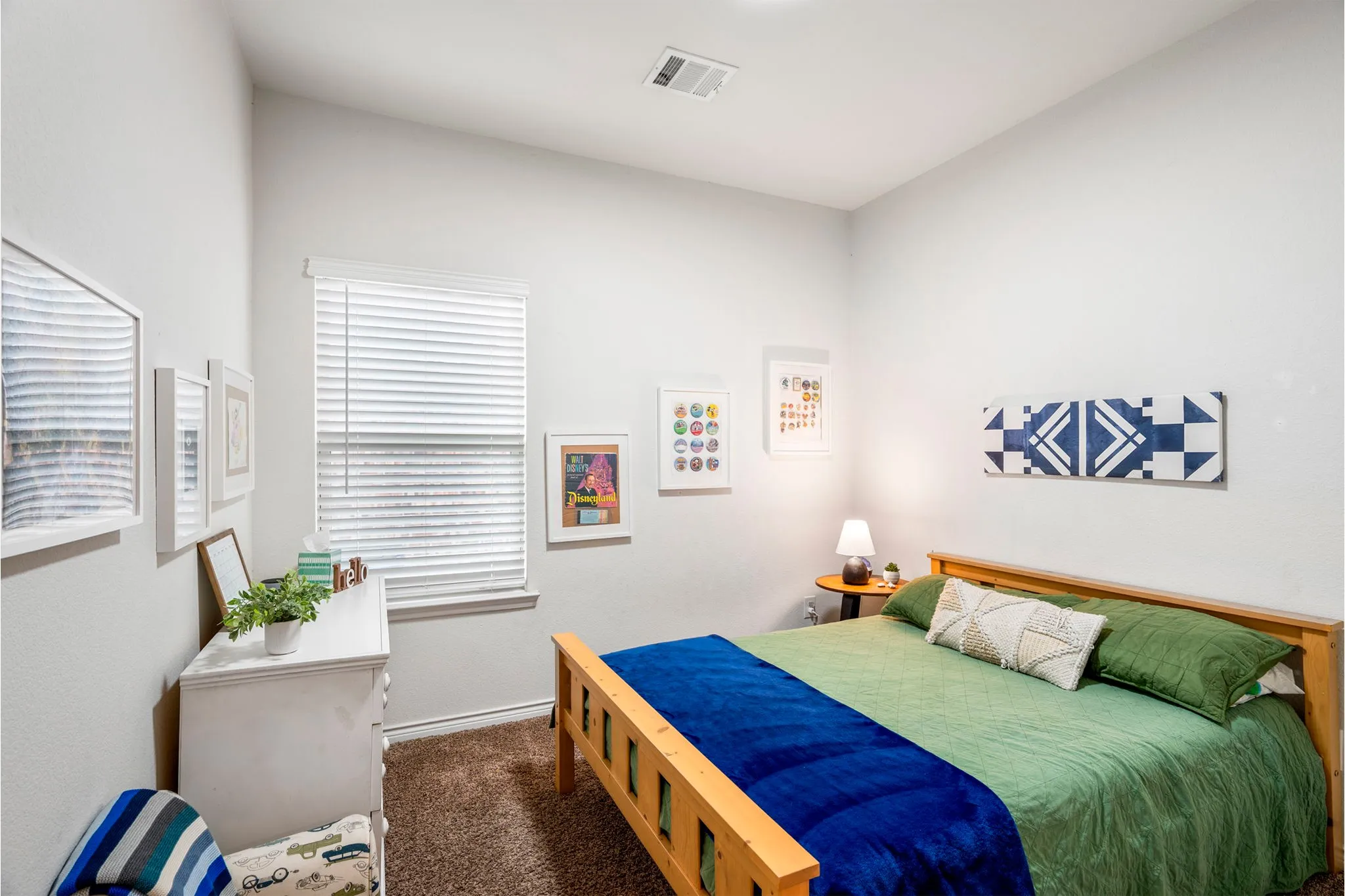 Bedroom featuring neutral wall paint, a single window with horizontal blinds, and recessed ceiling lighting