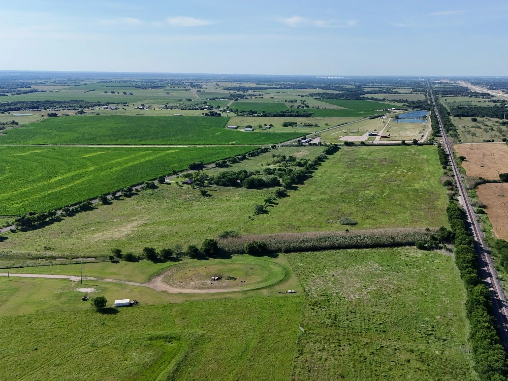 Expansive agricultural land featuring a blend of cultivated fields and open pastures