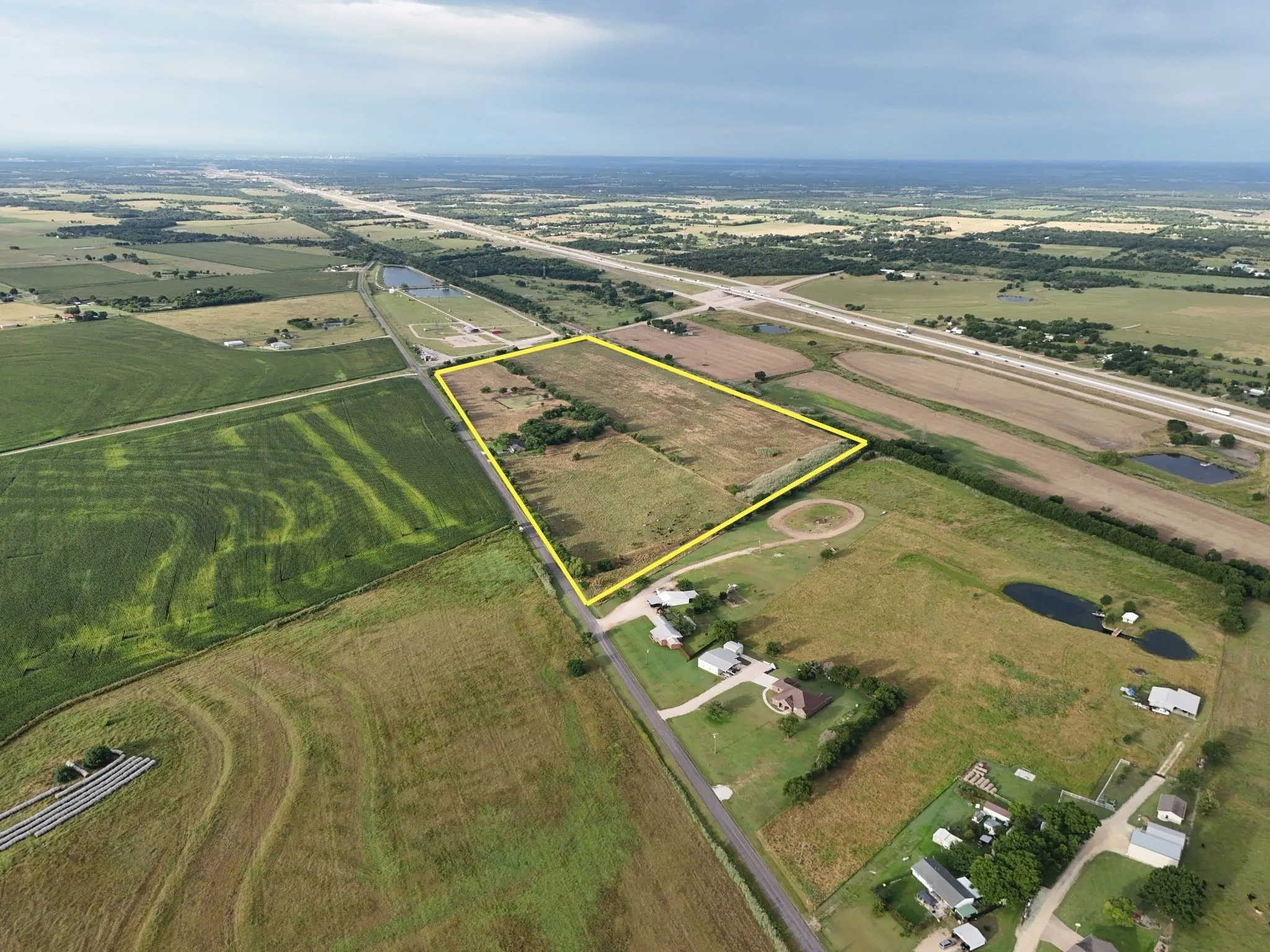 Expansive land parcel featuring clear boundaries, direct road frontage, and varied terrain