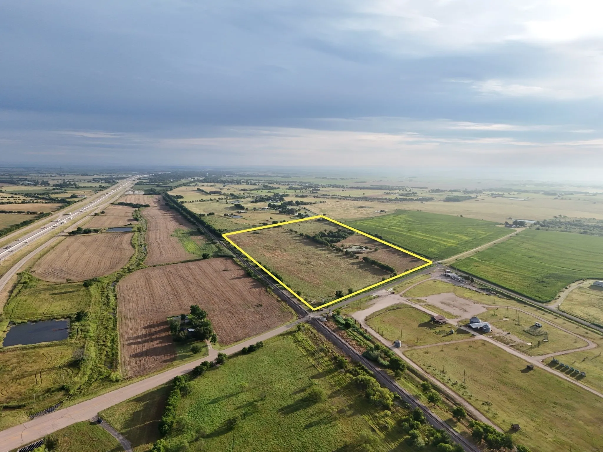 Expansive rectangular land parcel featuring a mix of cultivated and uncultivated ground