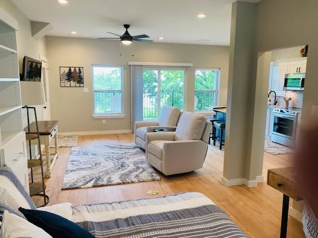 Living room featuring ceiling fan, light wood-type flooring, plenty of natural light, and recessed lighting