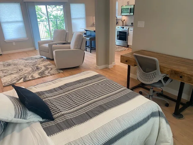 Bedroom featuring light wood-type flooring and baseboards