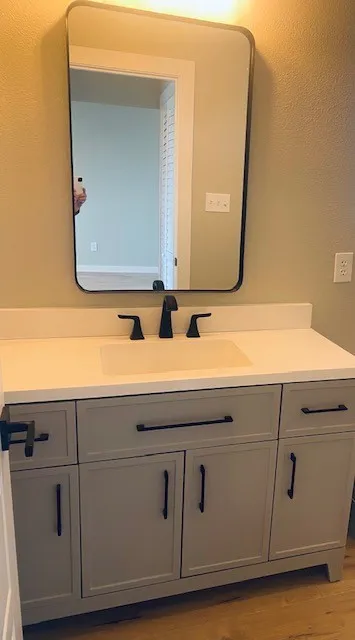 Bathroom featuring vanity and wood finished floors