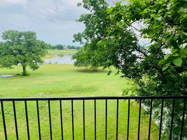 View of grassy yard with a water view
