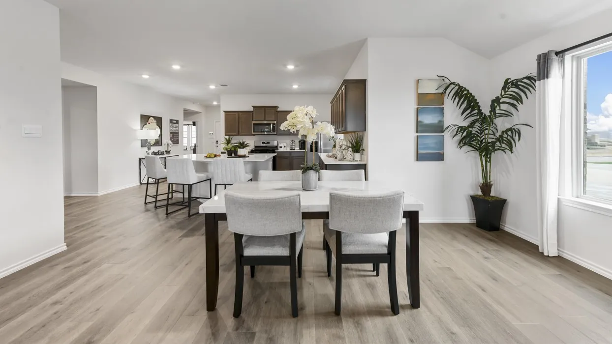 Open-concept living area featuring wood-finish flooring, recessed lighting, and white walls