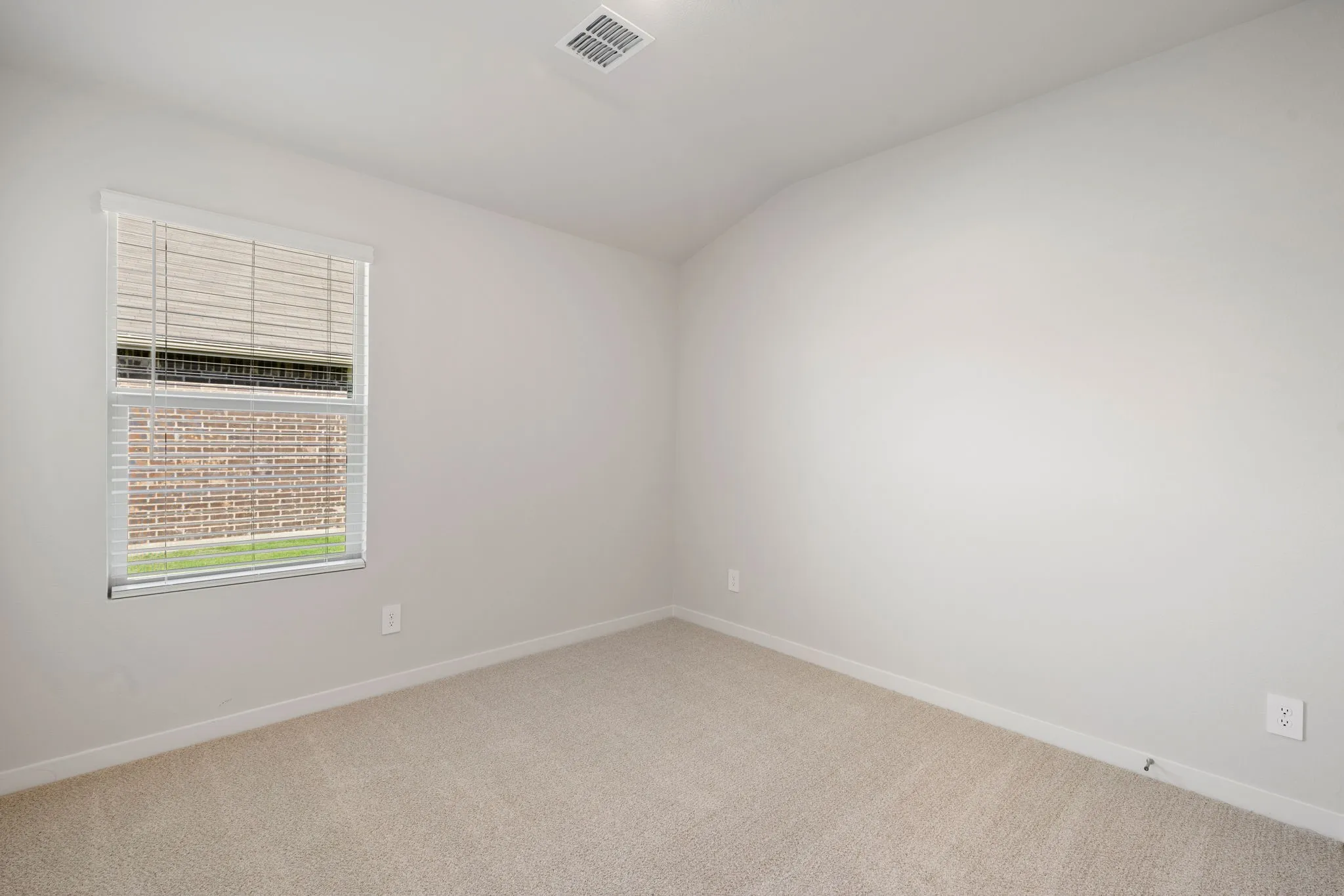 Neutral-toned carpet flooring and light-colored wall paint