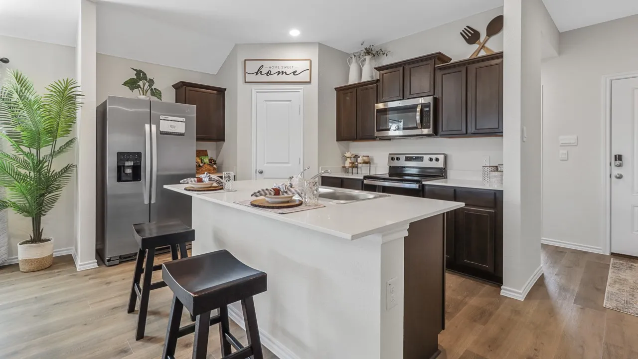 Kitchen featuring an island with a white countertop and integrated sink