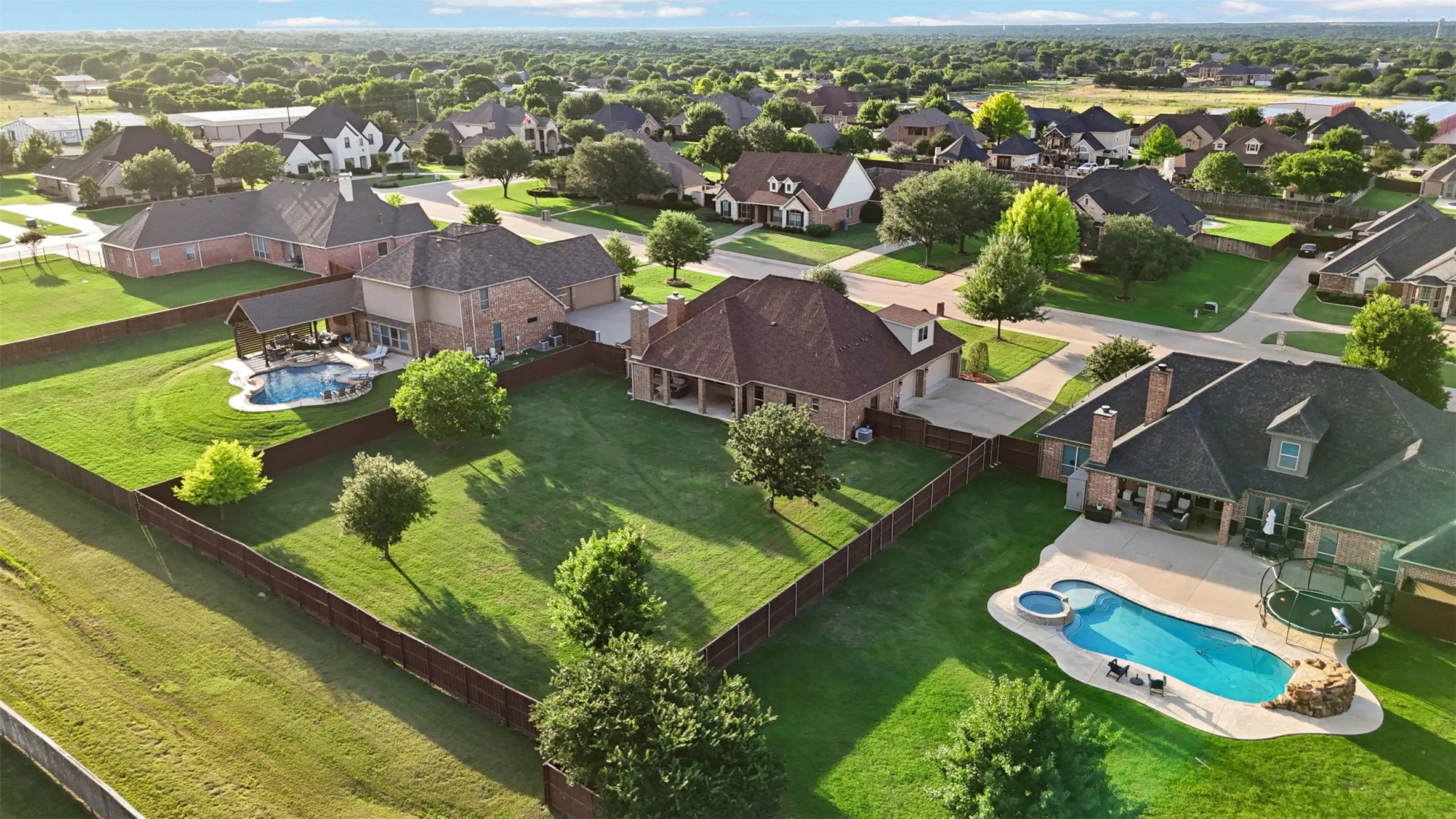 Expansive property featuring two distinct swimming pools, each with an integrated spa