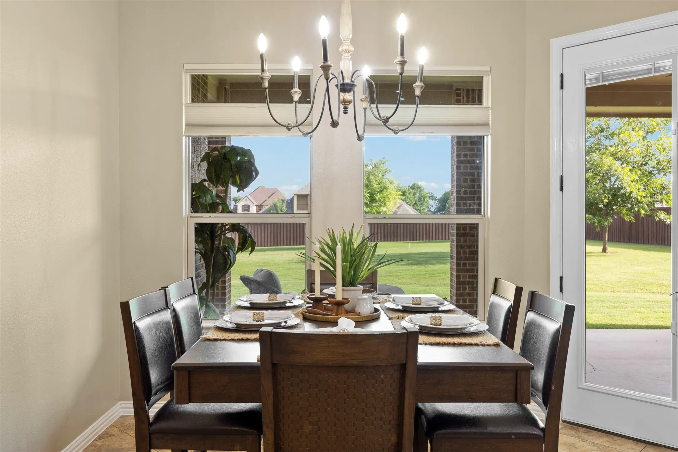 Dining area featuring a classic chandelier and multiple windows