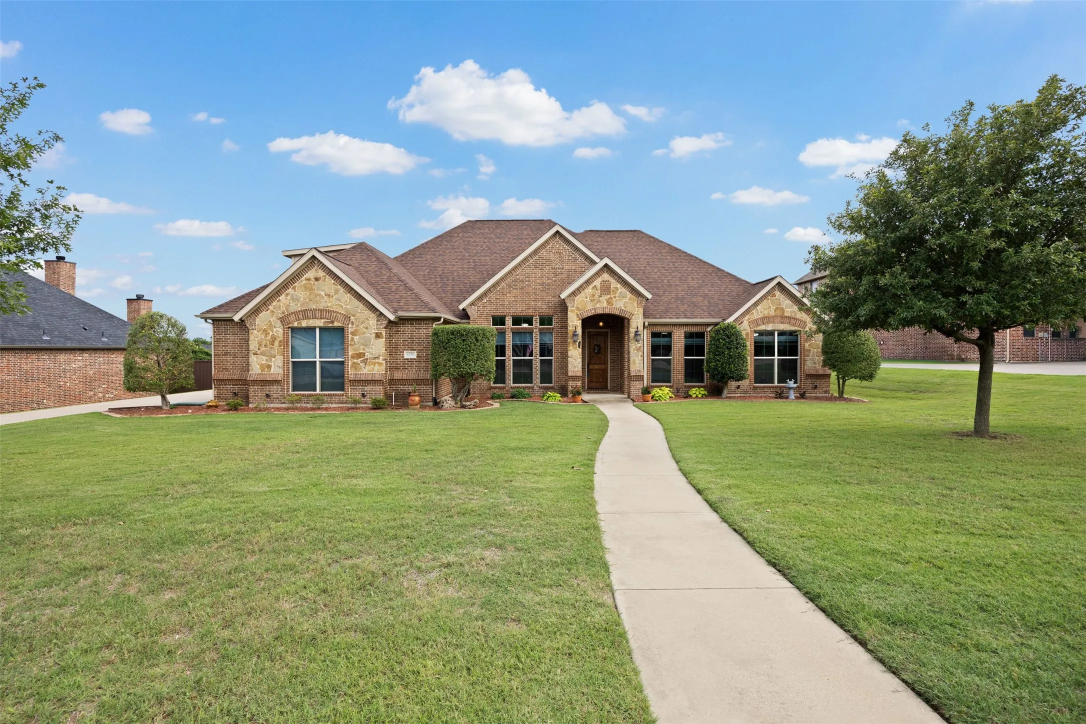 Spacious single-story home featuring a combination brick and stone exterior