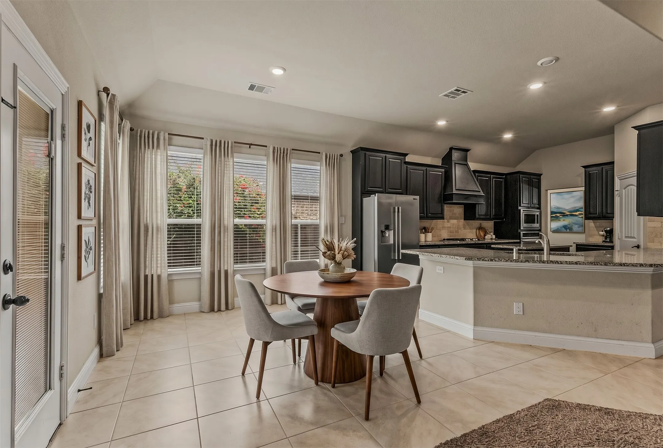 Open-concept kitchen and dining area featuring tile flooring