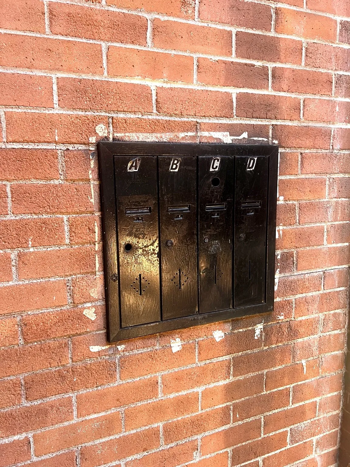 Built-in black metal mailbox unit with an original vintage mail box (no longer in use)