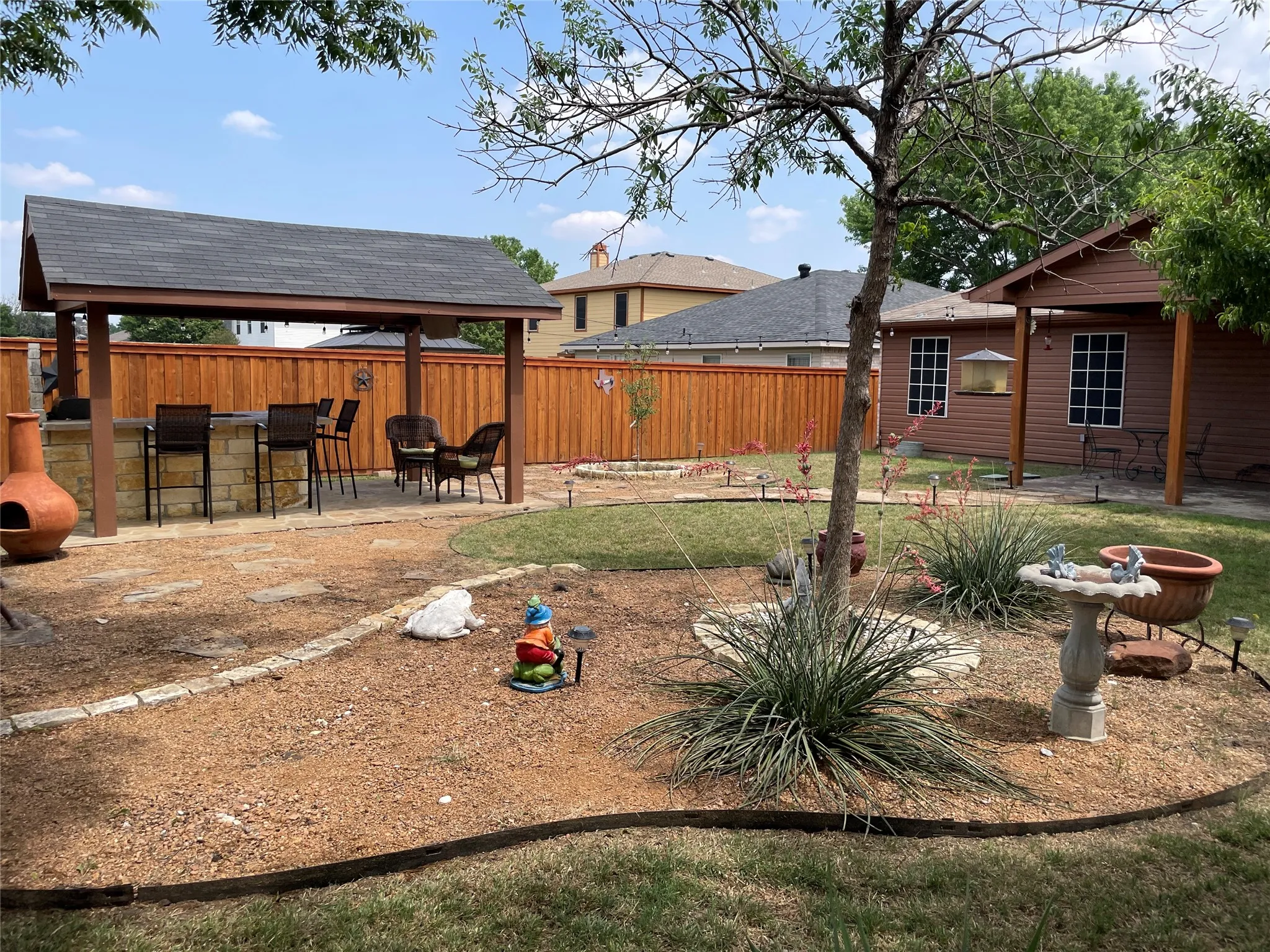 View of yard with exterior bar, a gazebo, and a patio