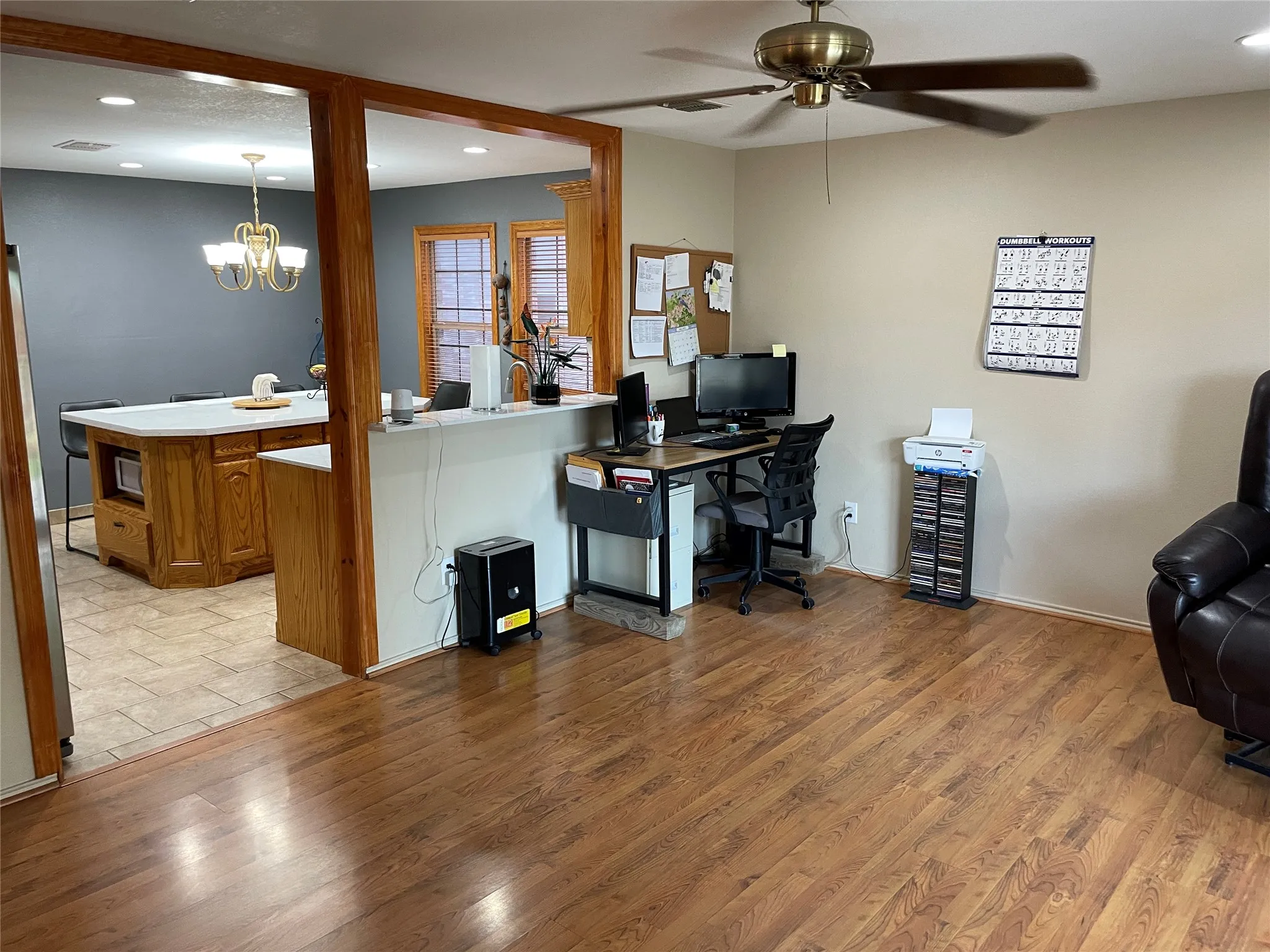 Second living area with ceiling fan with notable  light wood-type flooring