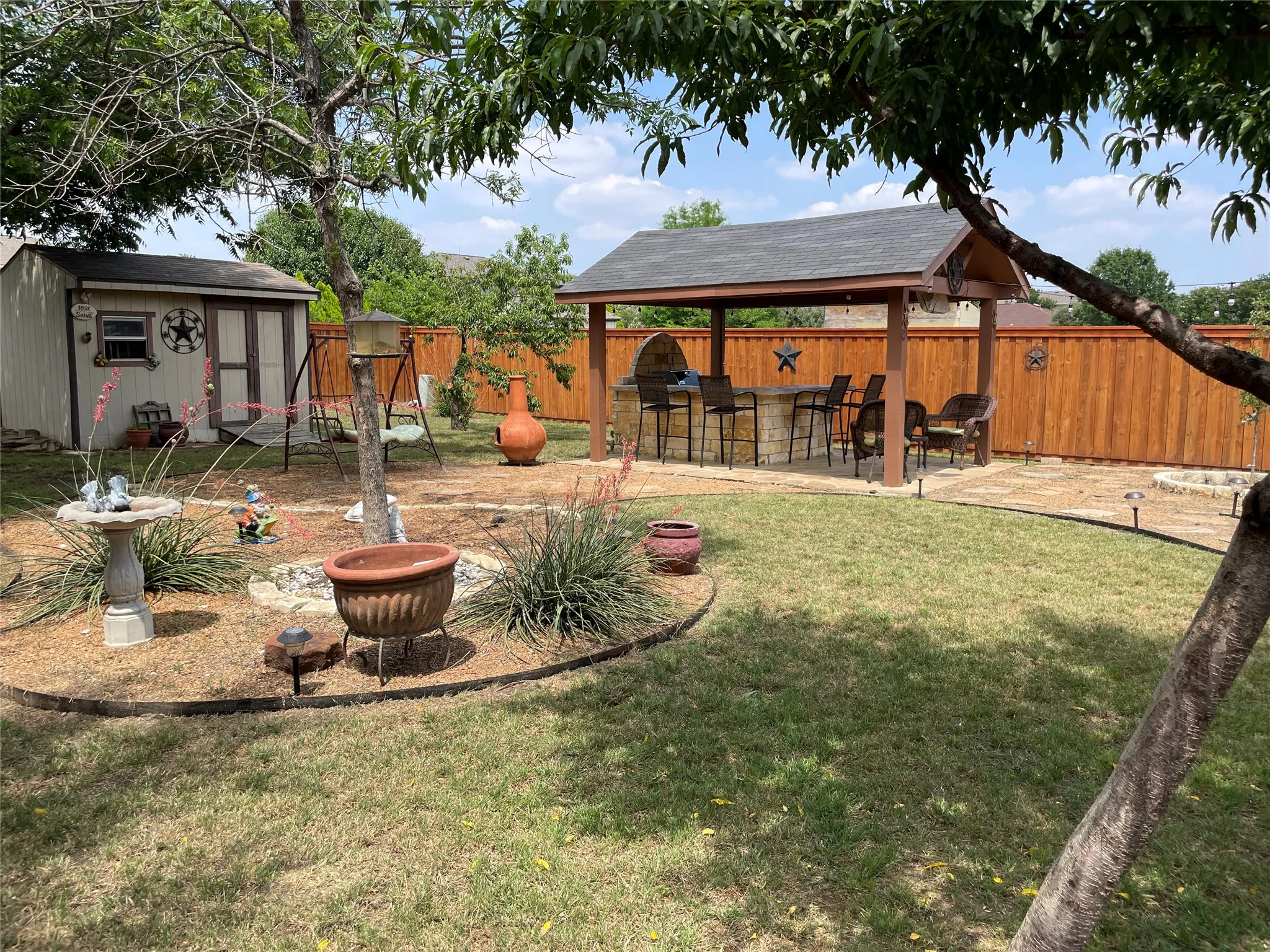 View of yard featuring a bar, a patio area, and a gazebo
