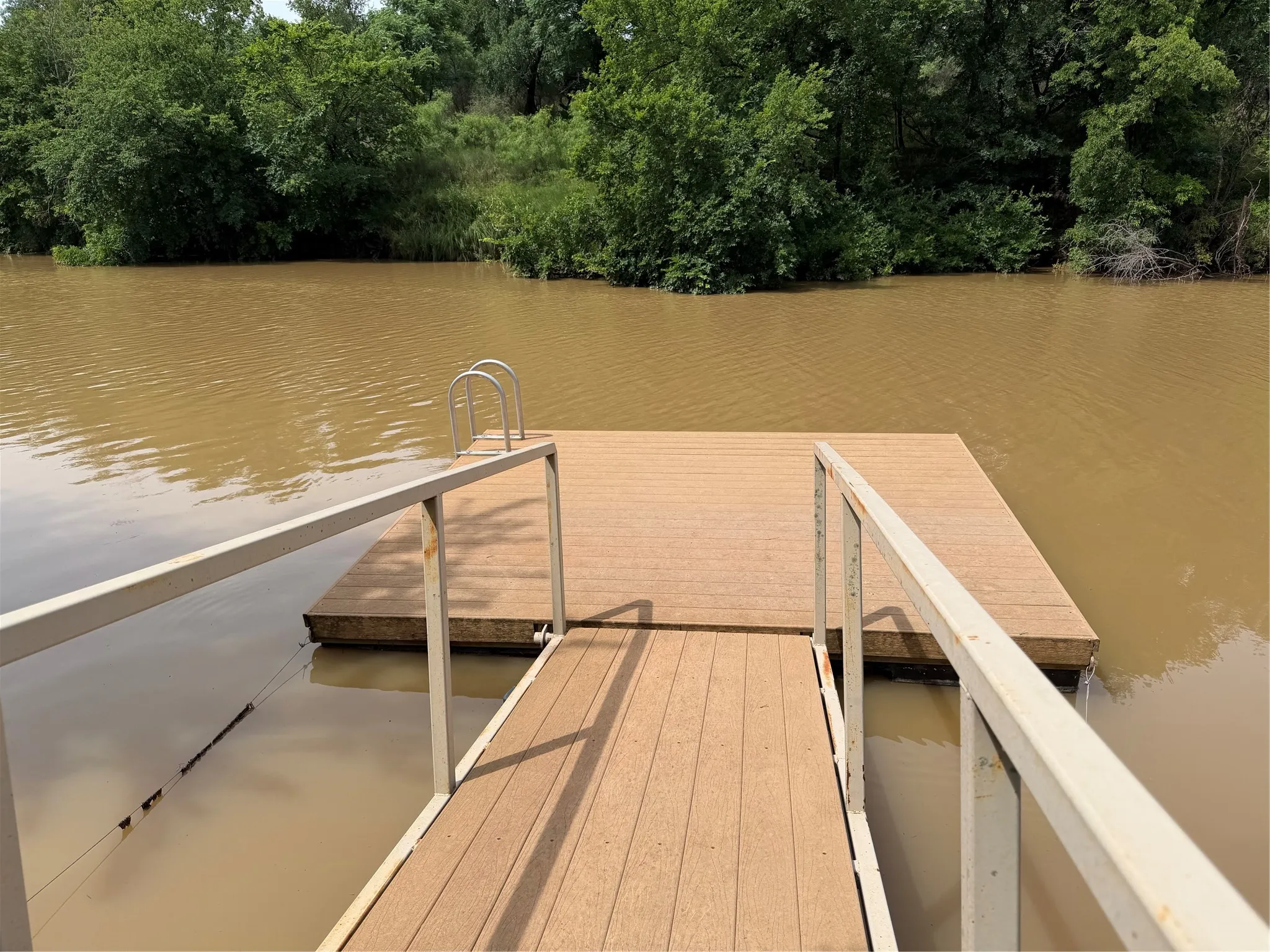 Floating dock with integrated ladder and metal handrails