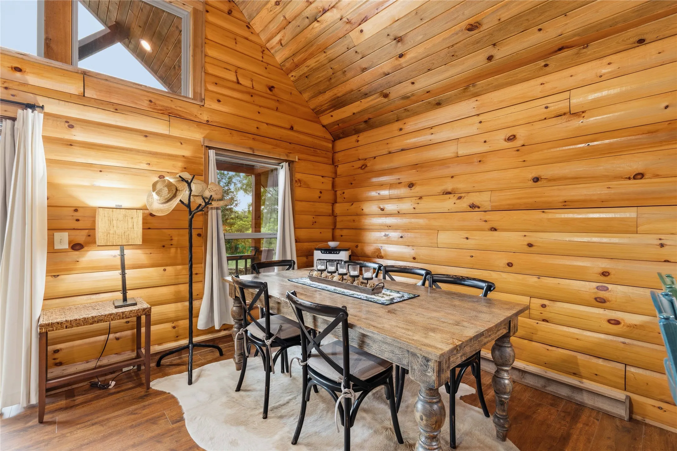 Expansive wood-paneled walls and ceiling featuring a prominent window