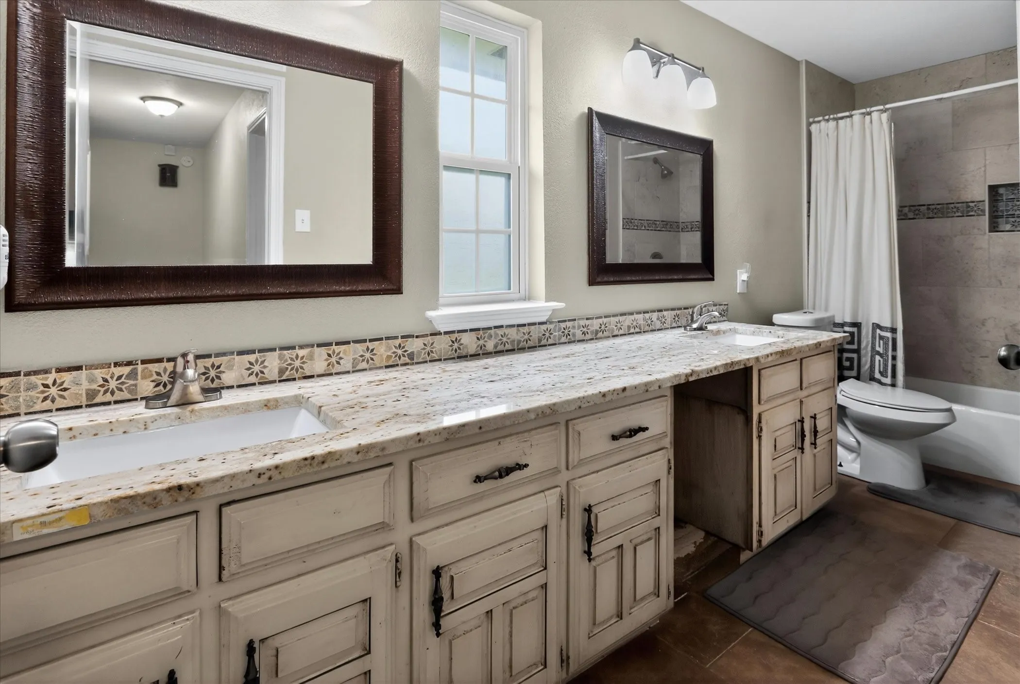 2nd bathroom with double sinks and tub.