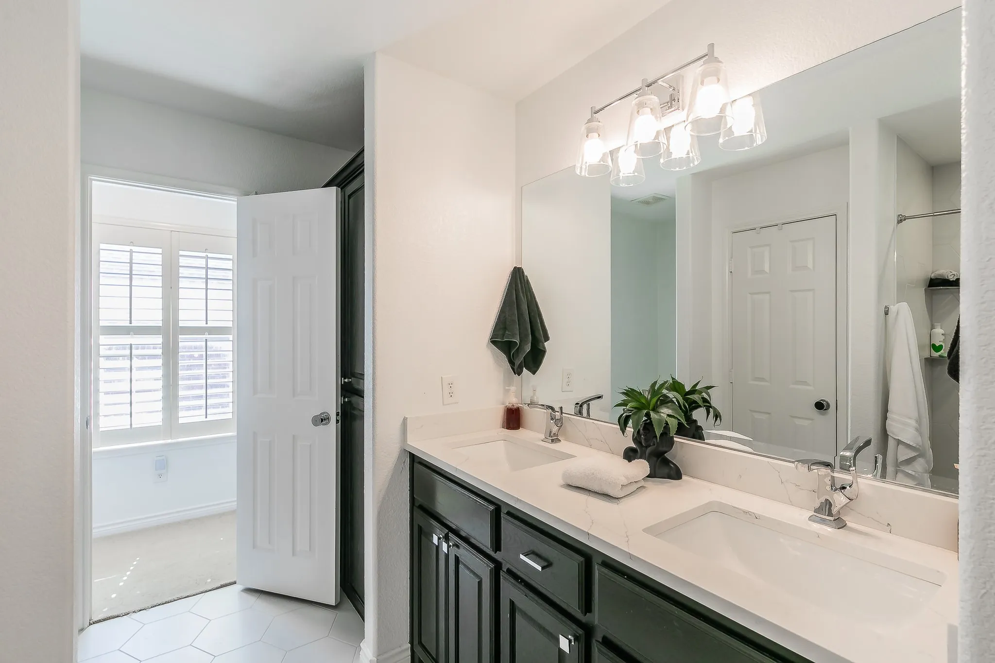 Full bath with double vanity and a sink
