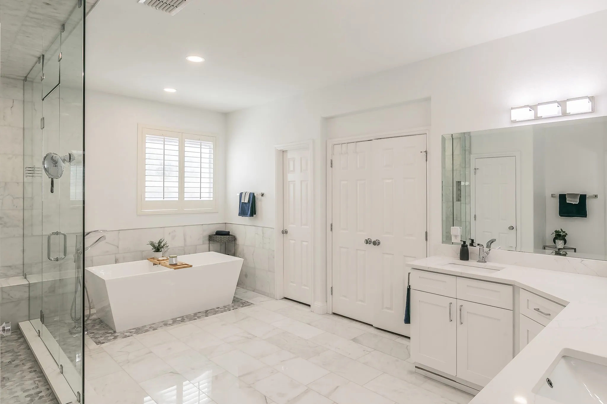 Bathroom featuring a shower stall, a freestanding bath, recessed lighting, marble finish floor, and vanity
