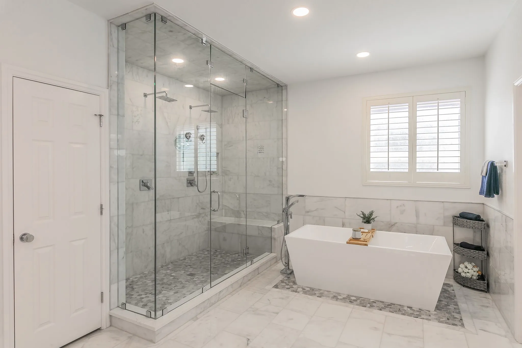 Bathroom featuring recessed lighting, a freestanding bath, marble finish floor, and a stall shower
