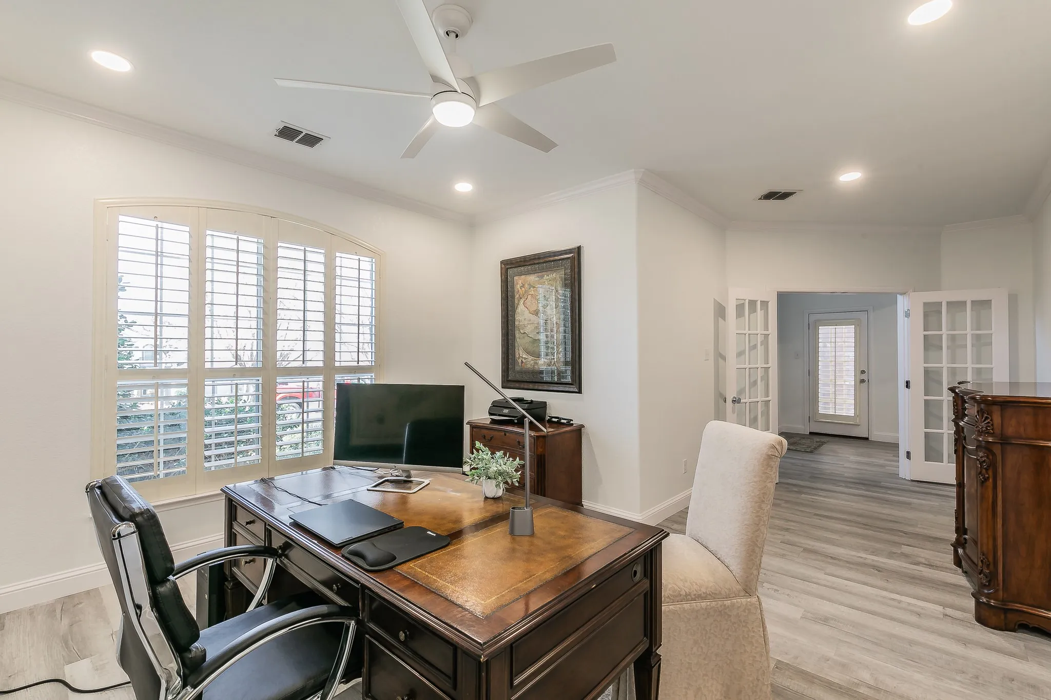 Office featuring visible vents, light wood-style floors, ornamental molding, and french doors